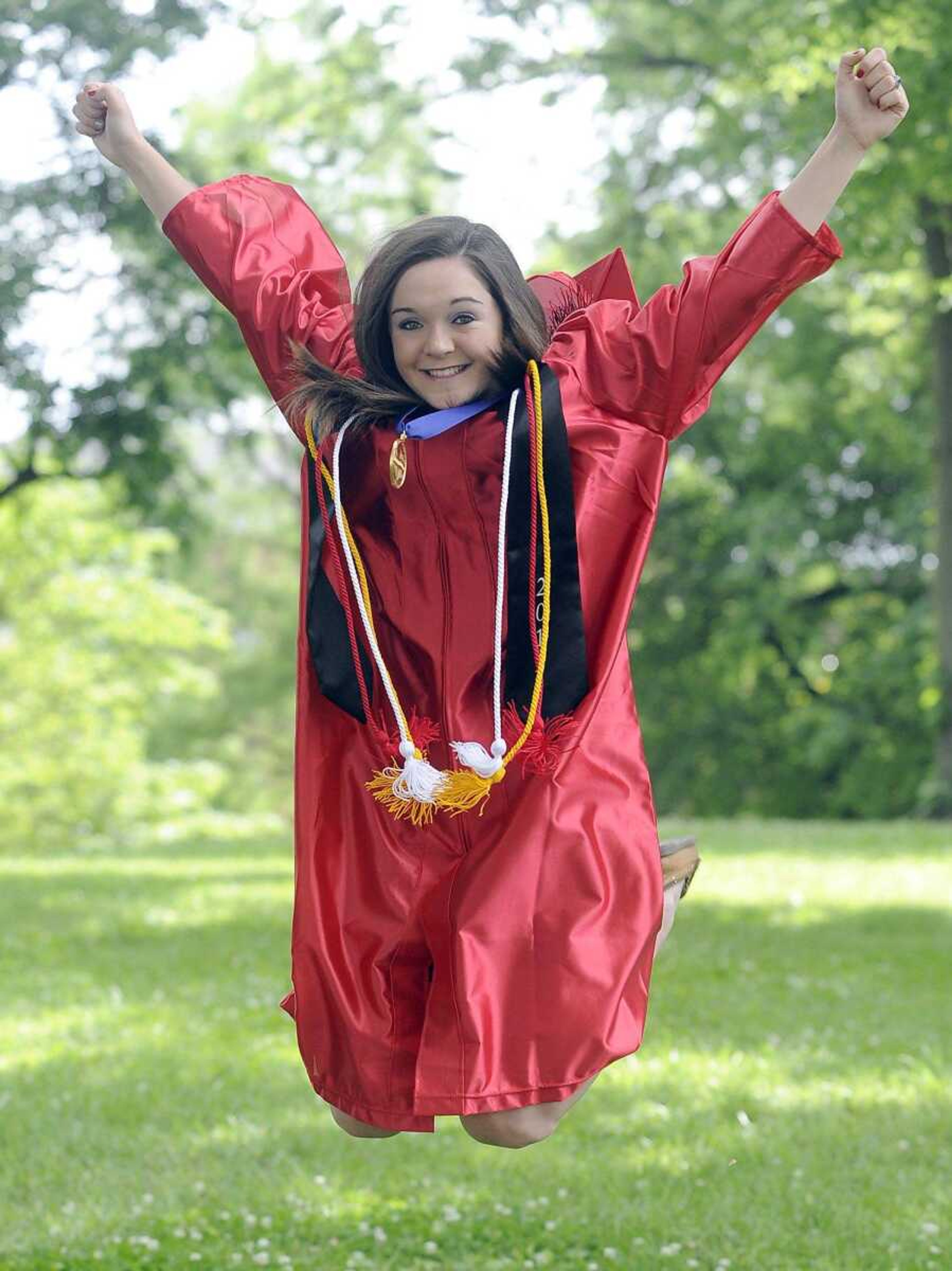 Emma Cook, 2015 Meadow Heights High School valedictorian, jumps for joy as she celebrates graduation. (Fred Lynch)