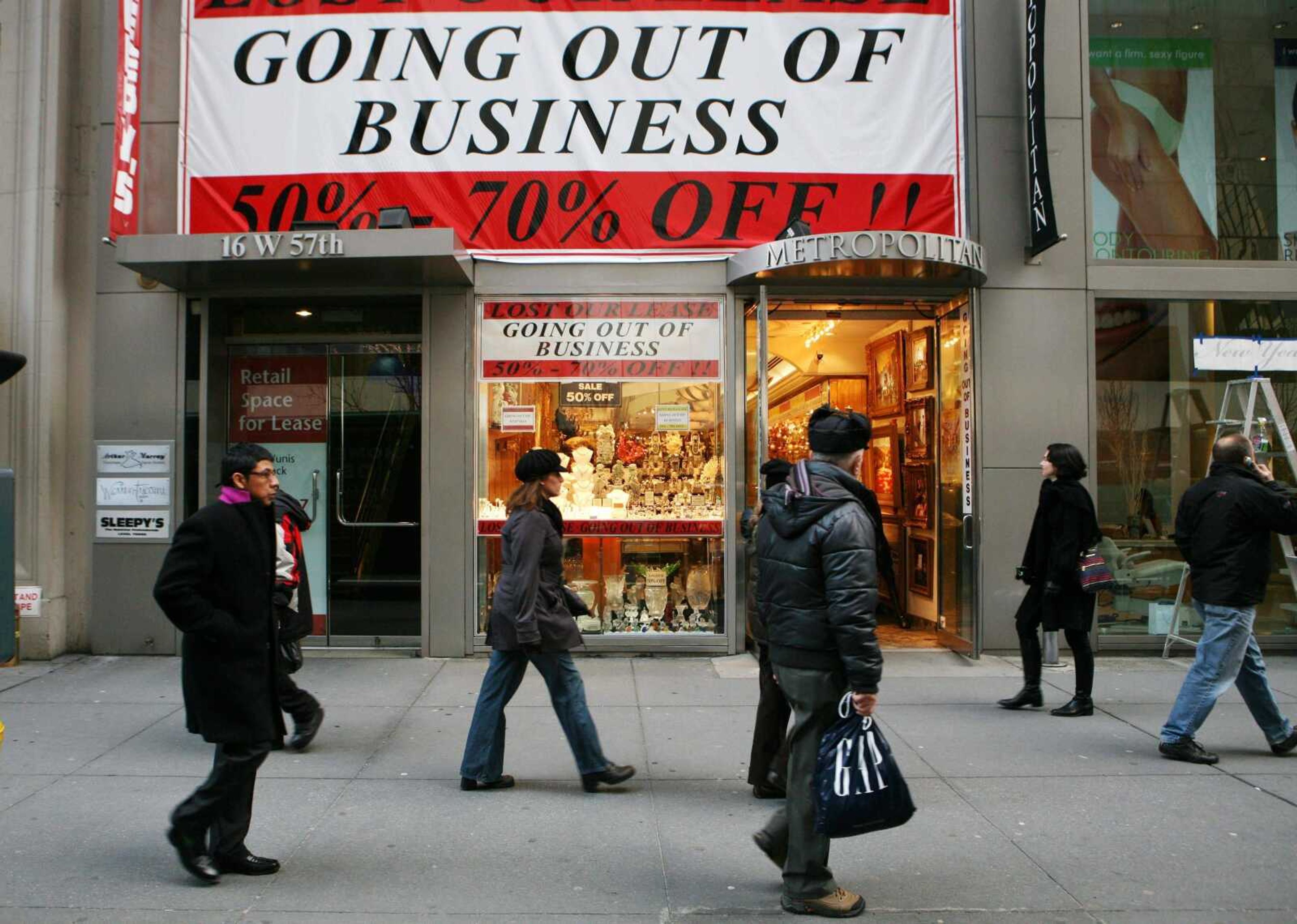 MARK LENNIHAN ~ Associated Press<br>People pass a jewelry store Thursday that is going out of business in New York. President-elect Barack Obama warned of dire and long-lasting consequences if Congress doesn't pump unprecedented dollars into the national economy, making an urgent pitch Thursday for his mammoth spending proposal in his first speech since the election.