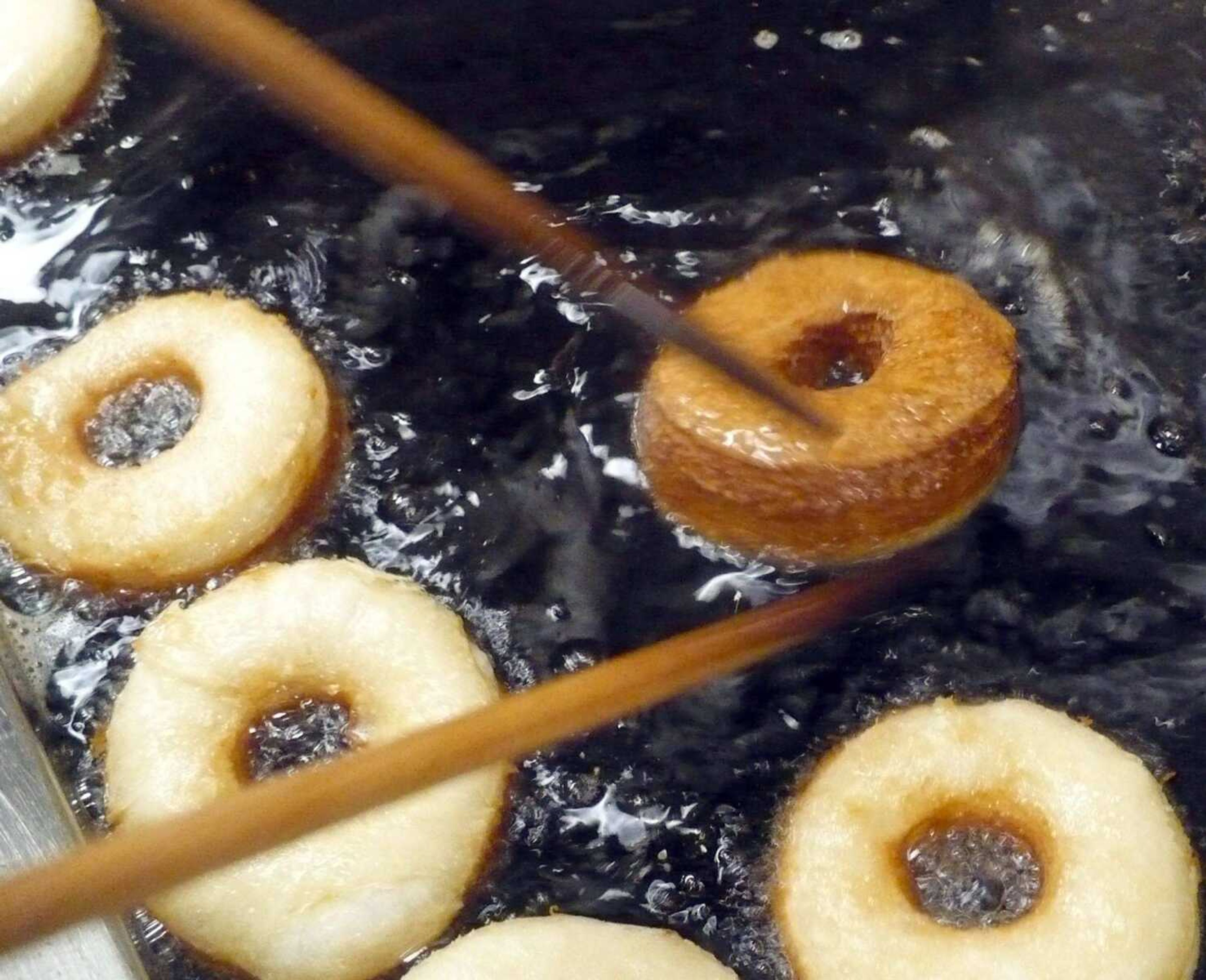 Cronuts in the deep fat fryer at a Schnucks bakery are browned on one side and ready for turning. A tax break sought by the Missouri House intends to overturn a recent state Supreme Court ruling that denied a utility sales tax exemption for the food warmed and served at Schnucks grocery stores. (Southeast Missourian file)