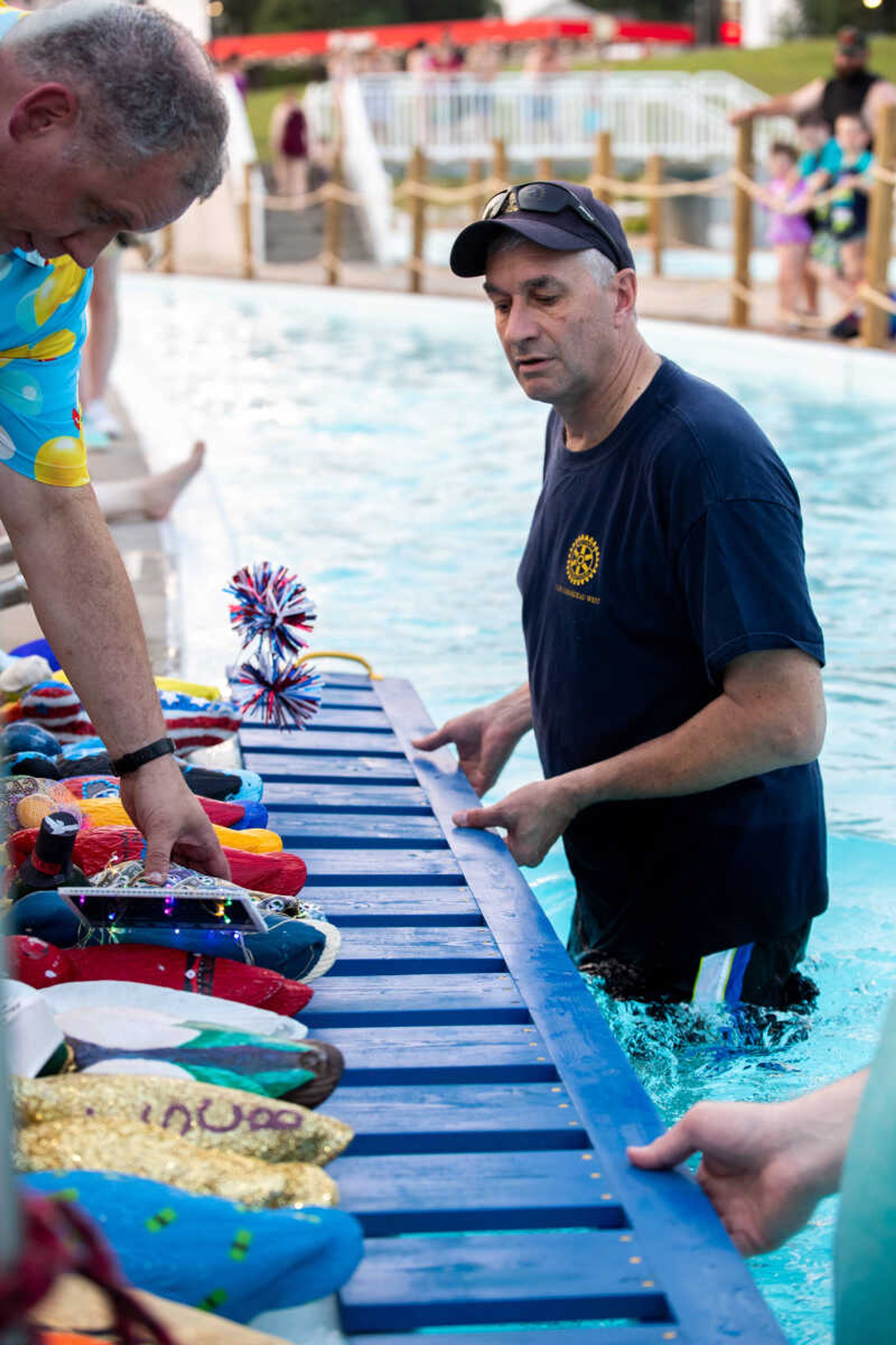 Will Gorman and Scott McClanahan put the corporate ducks on a wooden ramp during the Duck Regatta.