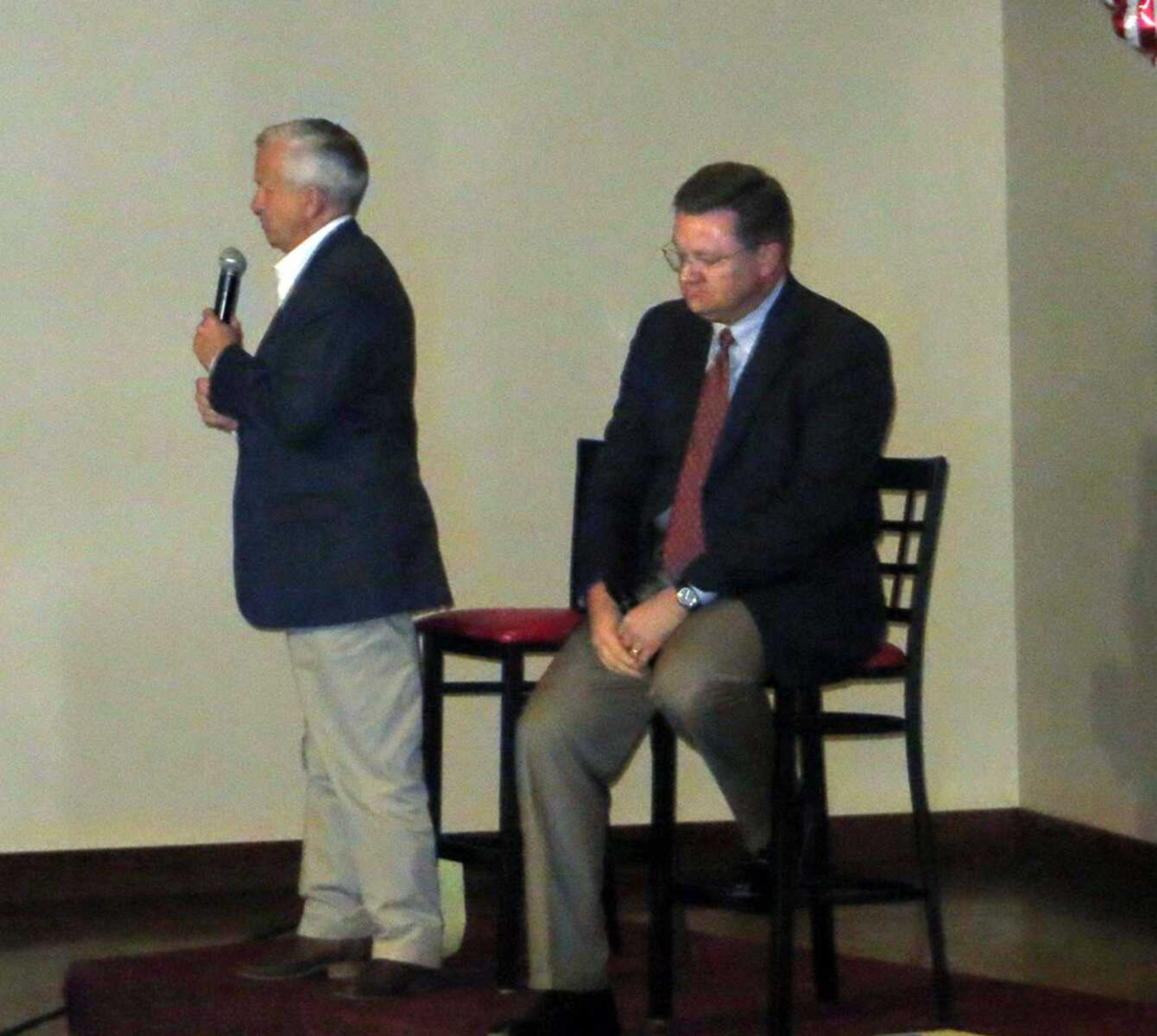 Bob Dixon, right, listens as fellow Missouri gubernatorial candidate John Brunner speaks during a candidates' forum Saturday night in Poplar Bluff, Mo. (Tyler Graef)