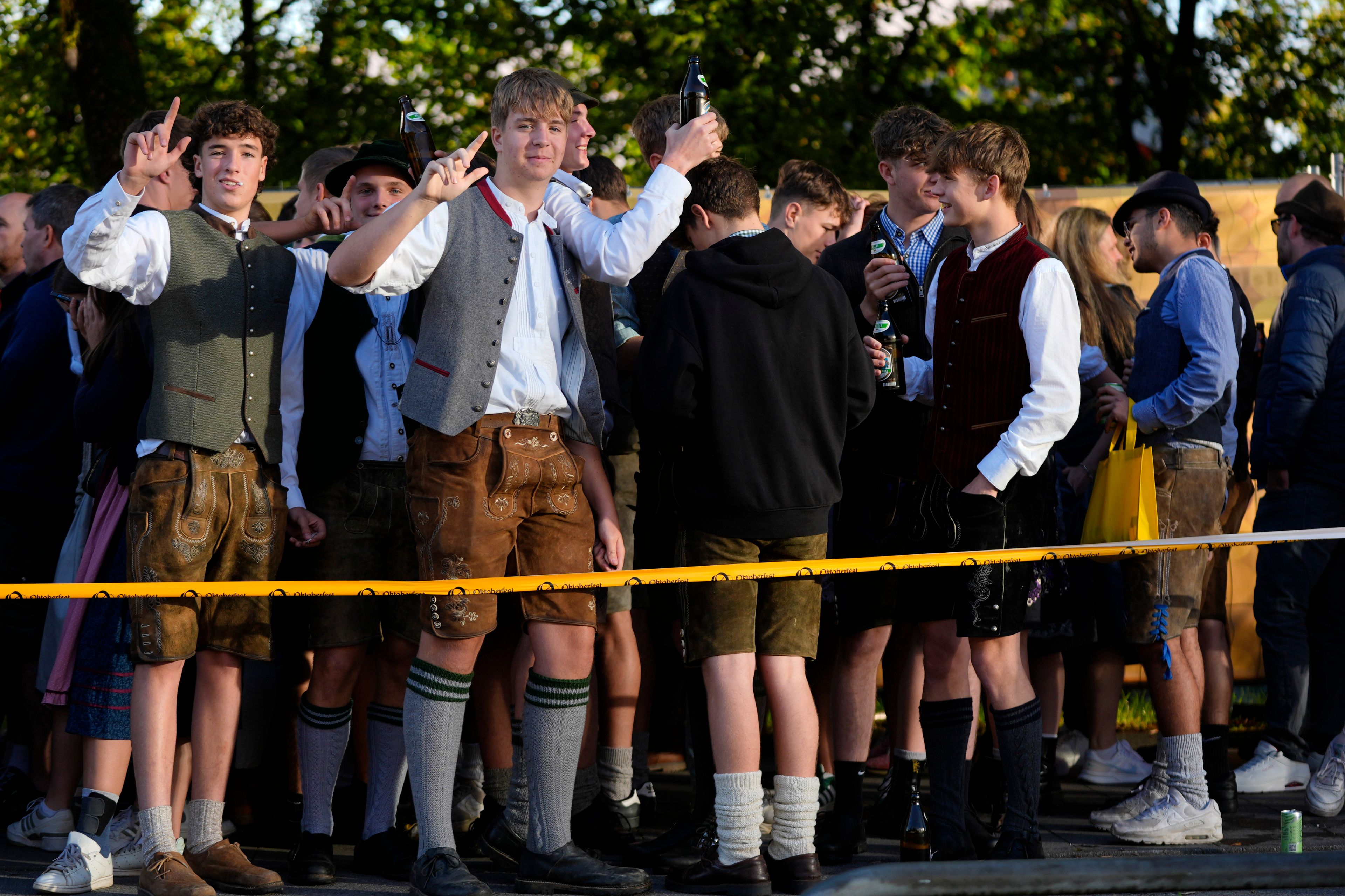 Young visitors await the start of the 189th 'Oktoberfest' beer festival in Munich, Germany, Saturday, Sept. 21, 2024. (AP Photo/Matthias Schrader)