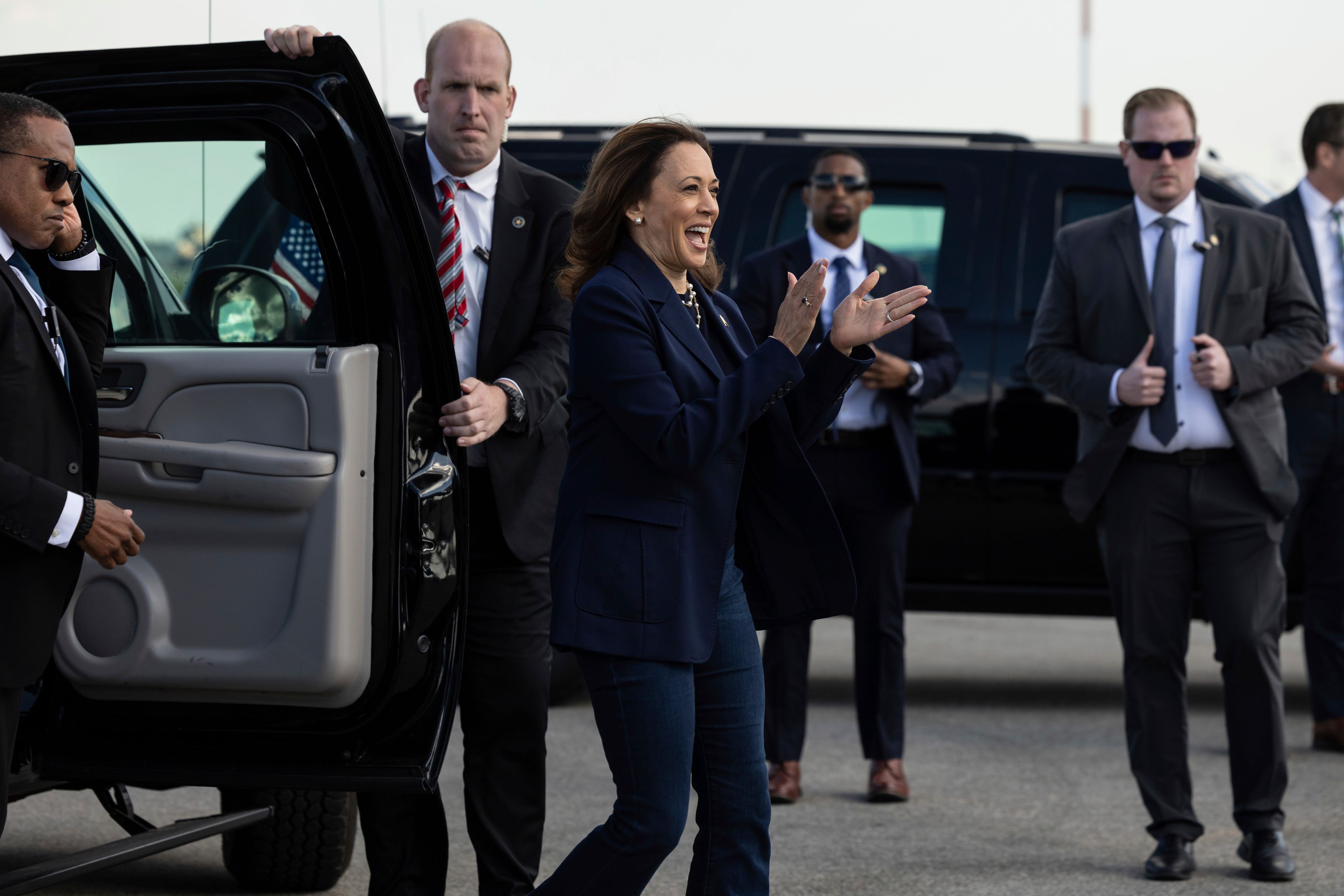 Democratic presidential nominee Vice President Kamala Harris claps hands at volunteers as she walks to board Air Force Two at LaGuardia International Airport, Wednesday, Oct. 9, 2024, in New York. (AP Photo/Yuki Iwamura)