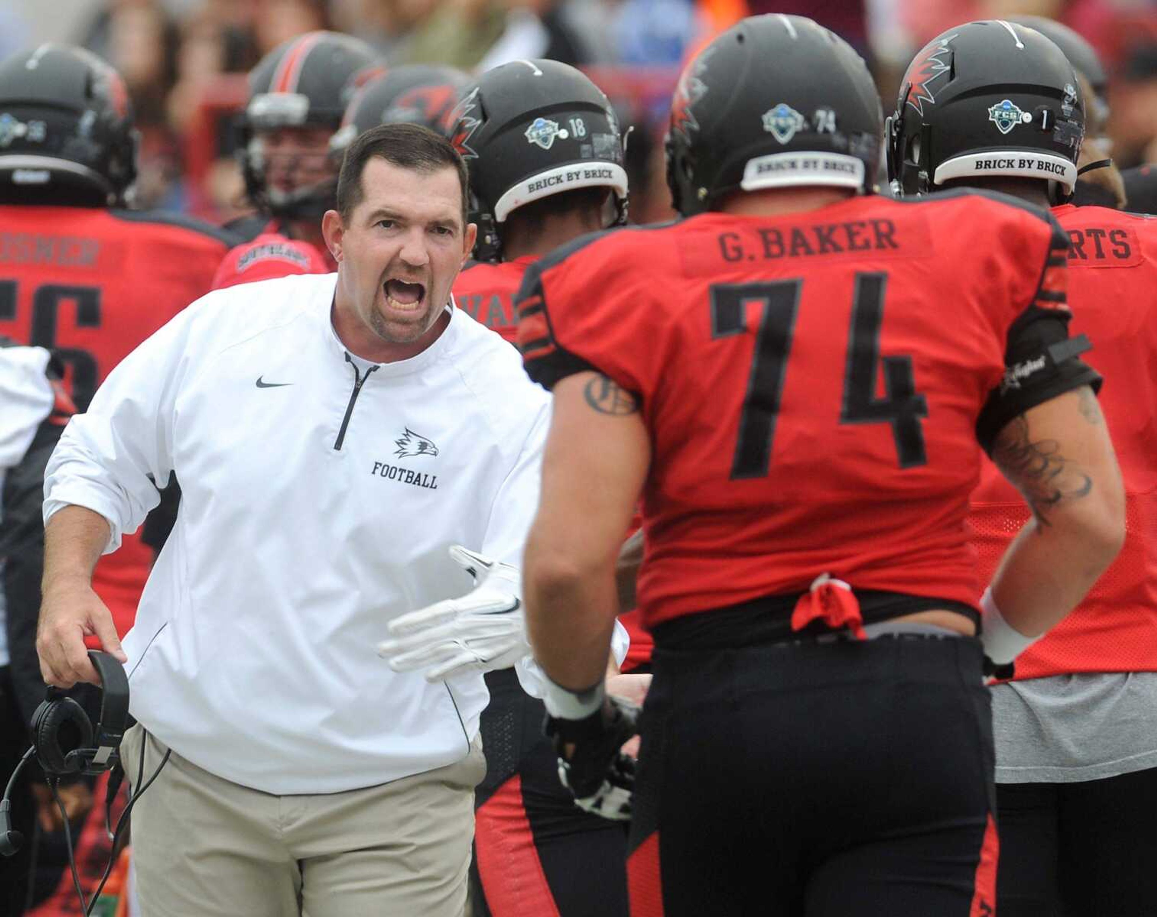 Southeast Missouri State coach Tom Matukewicz meets his players after they scored a touchdown against Shorter during the second quarter Saturday, Sept. 26, 2015 at Houck Stadium. (Fred Lynch)