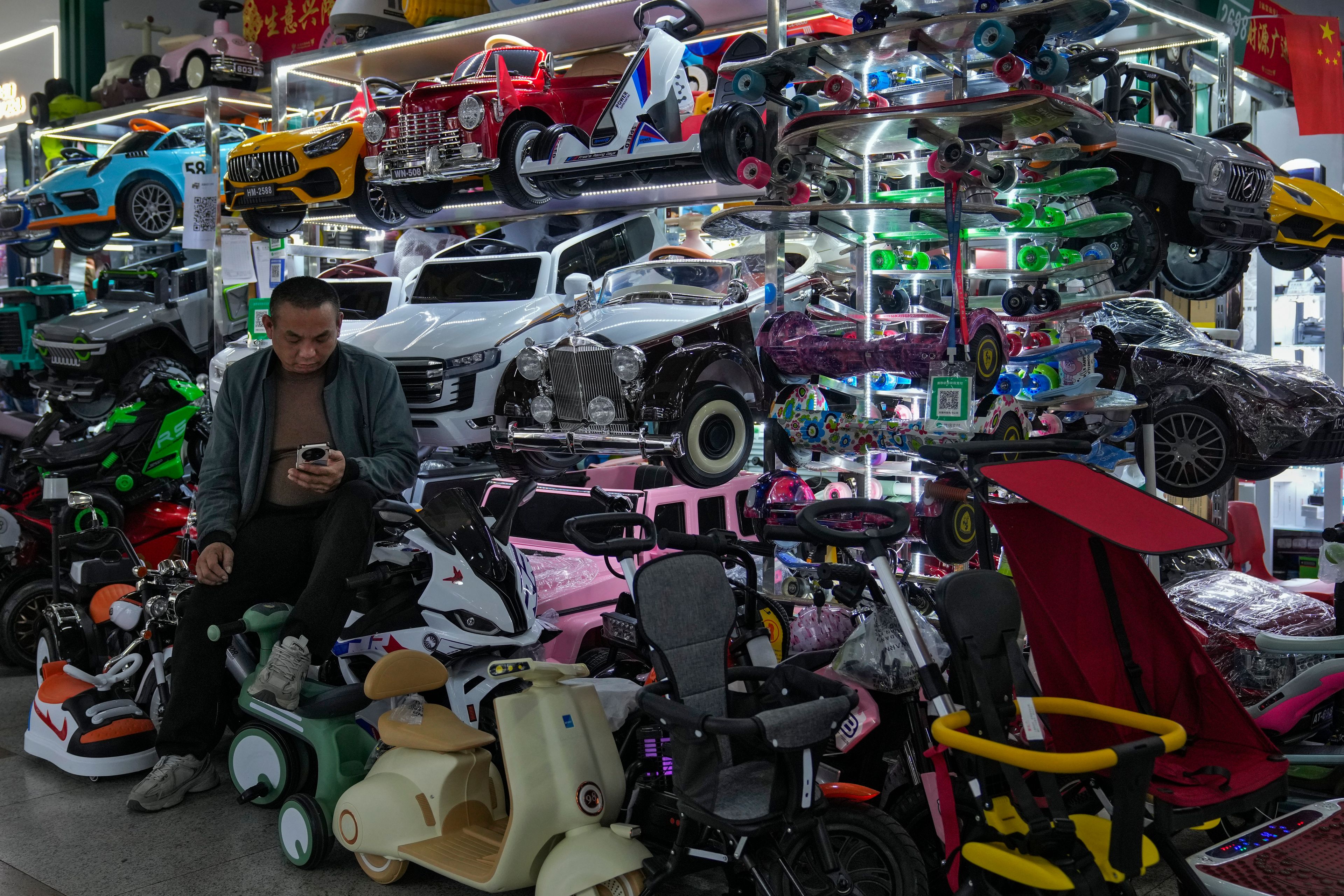 A vendor waits for customers at his store selling electric toy cars at the Yiwu wholesale market in Yiwu, east China's Zhejiang province on Nov. 8, 2024. (AP Photo/Andy Wong)