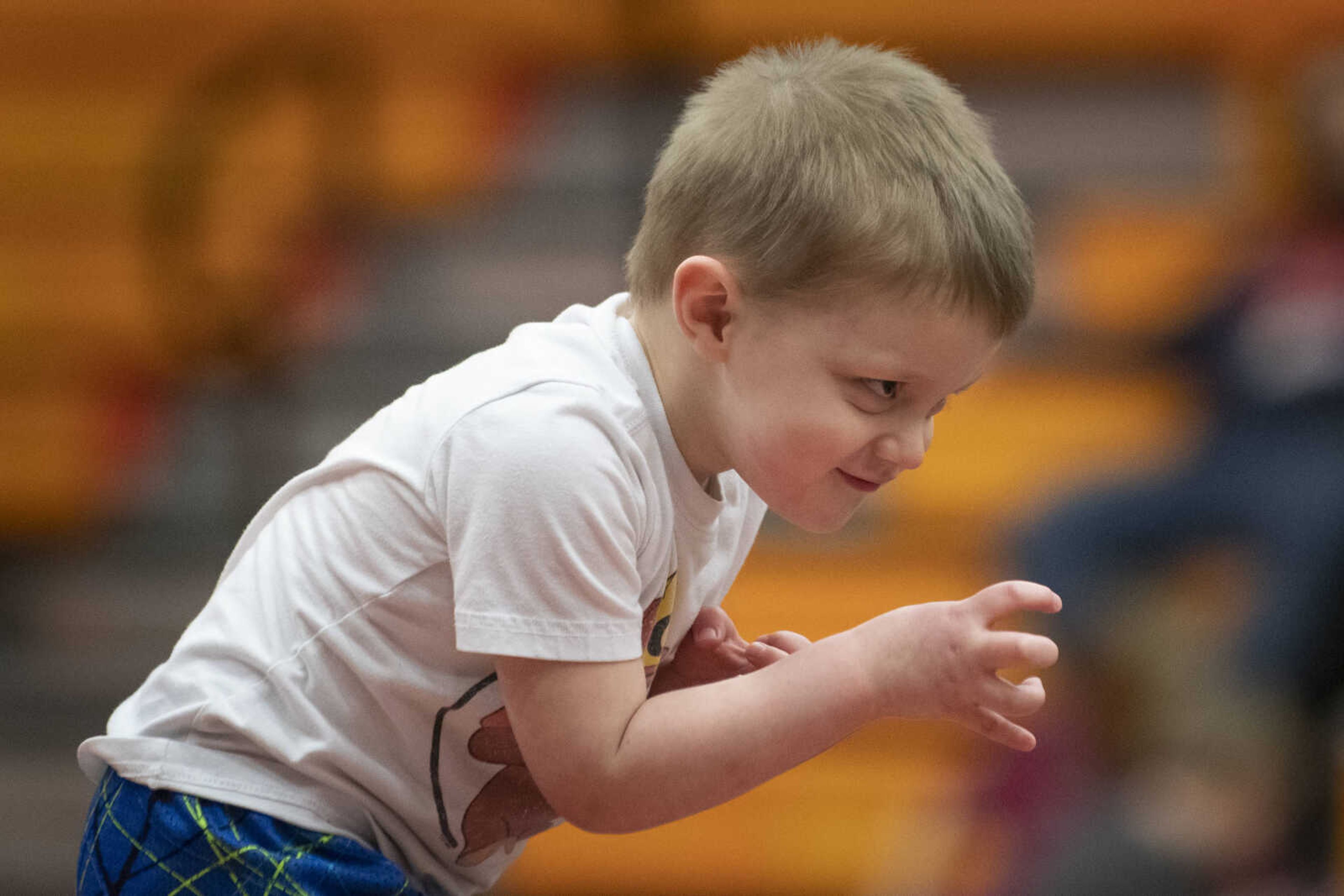 Lincoln Gerhardt of Jackson, 4, puts up his hands while preparing to take on an opponent during a match of Cape Girardeau Little League Wrestling on Tuesday, March 19, 2019, at Cape Central High School.