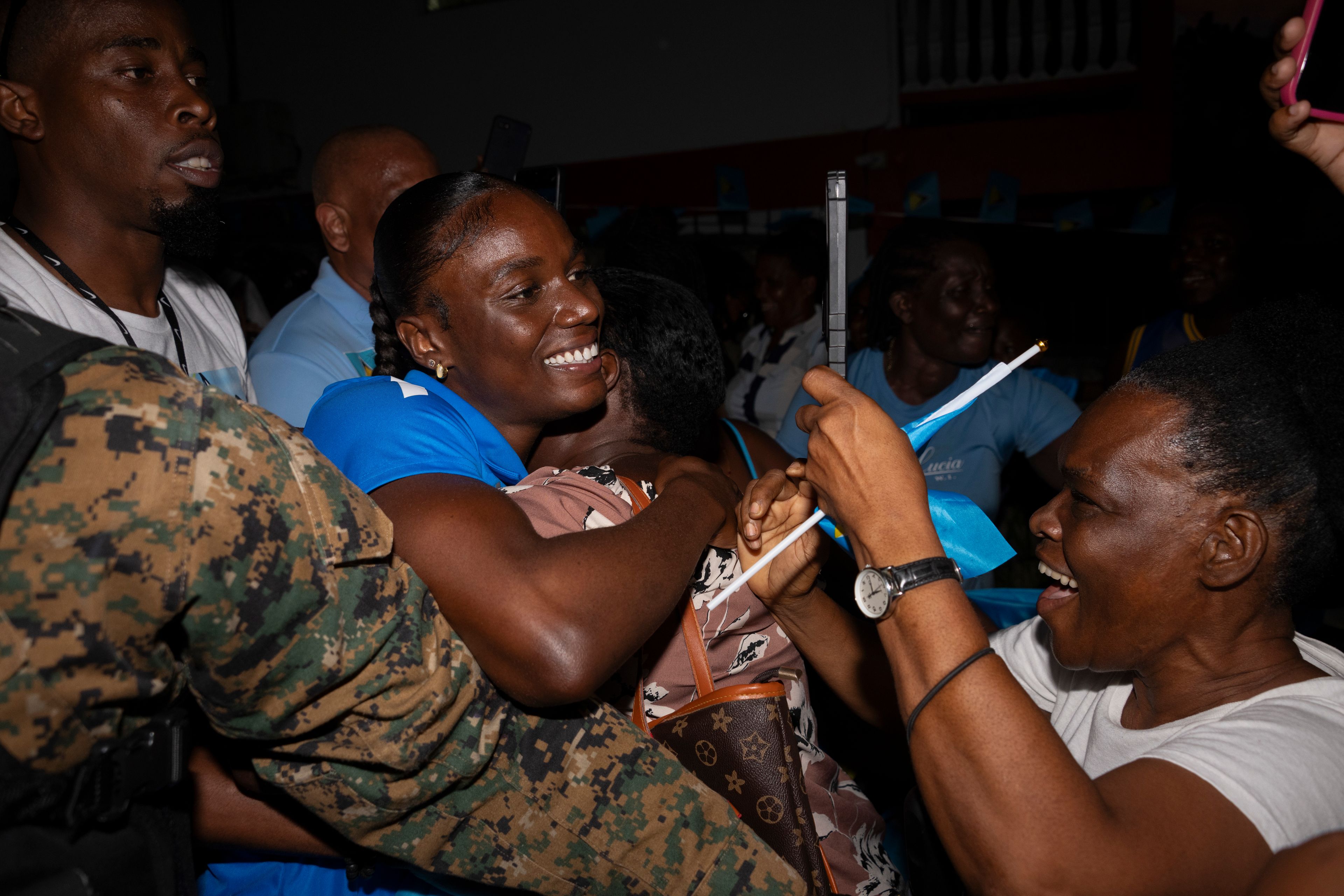 Julian Alfred, center, who won the 100-meter Olympic gold in Paris, is celebrated upon returning to Saint Lucia after winning the country's first Olympic medal, in Castries, Saint Lucia, Sept. 24, 2024. (AP Photo/Kirk Elliott)