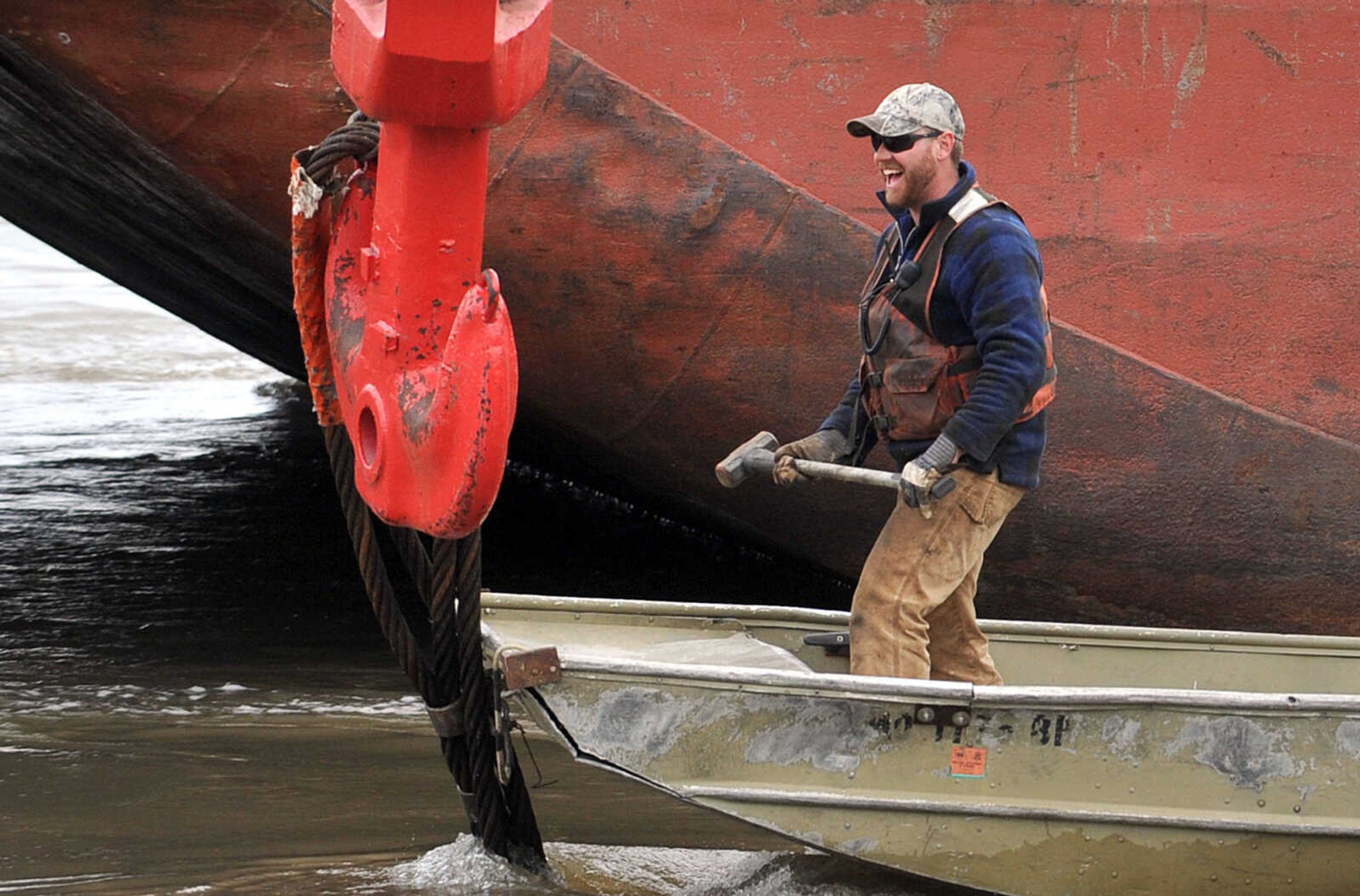 LAURA SIMON ~ lsimon@semissourian.com

Crews work to remove coal from the partially sunken barge in the Mississippi River  along the floodwall in downtown Cape Girardeau, Tuesday, April 2, 2013. The barge is one of 13 that broke loose from the Sheila Johnson on March 24 after it struck something in the river near mile marker 60 north of Cape Girardeau. A floating crane has a harness around the sunken portion while crews on a separate barge remove the coal.