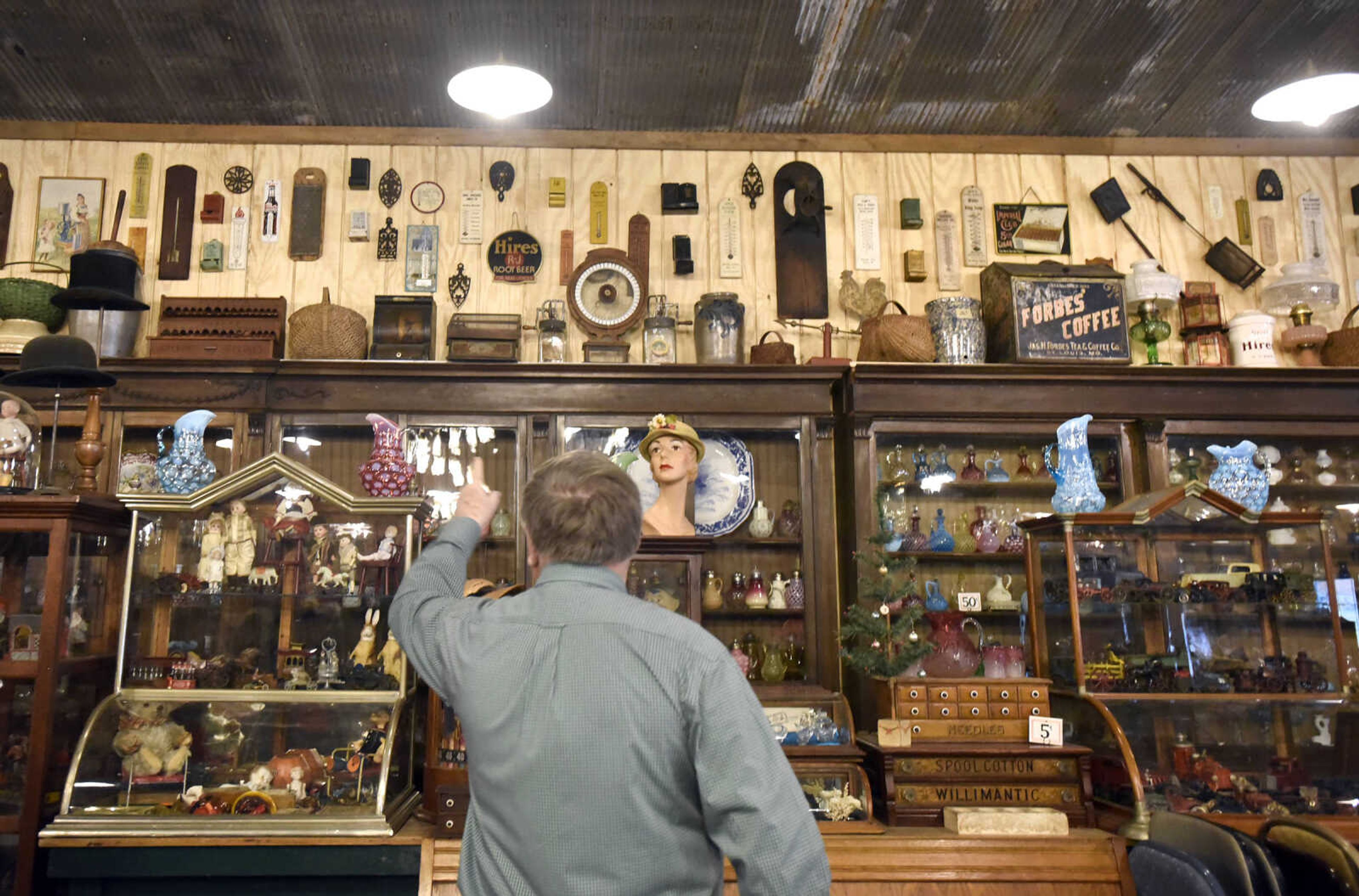 Harlan Smothers points to his collection of thermometers and matchboxes from mostly local businesses inside his Fat Chance General Store in Cape Girardeau County.