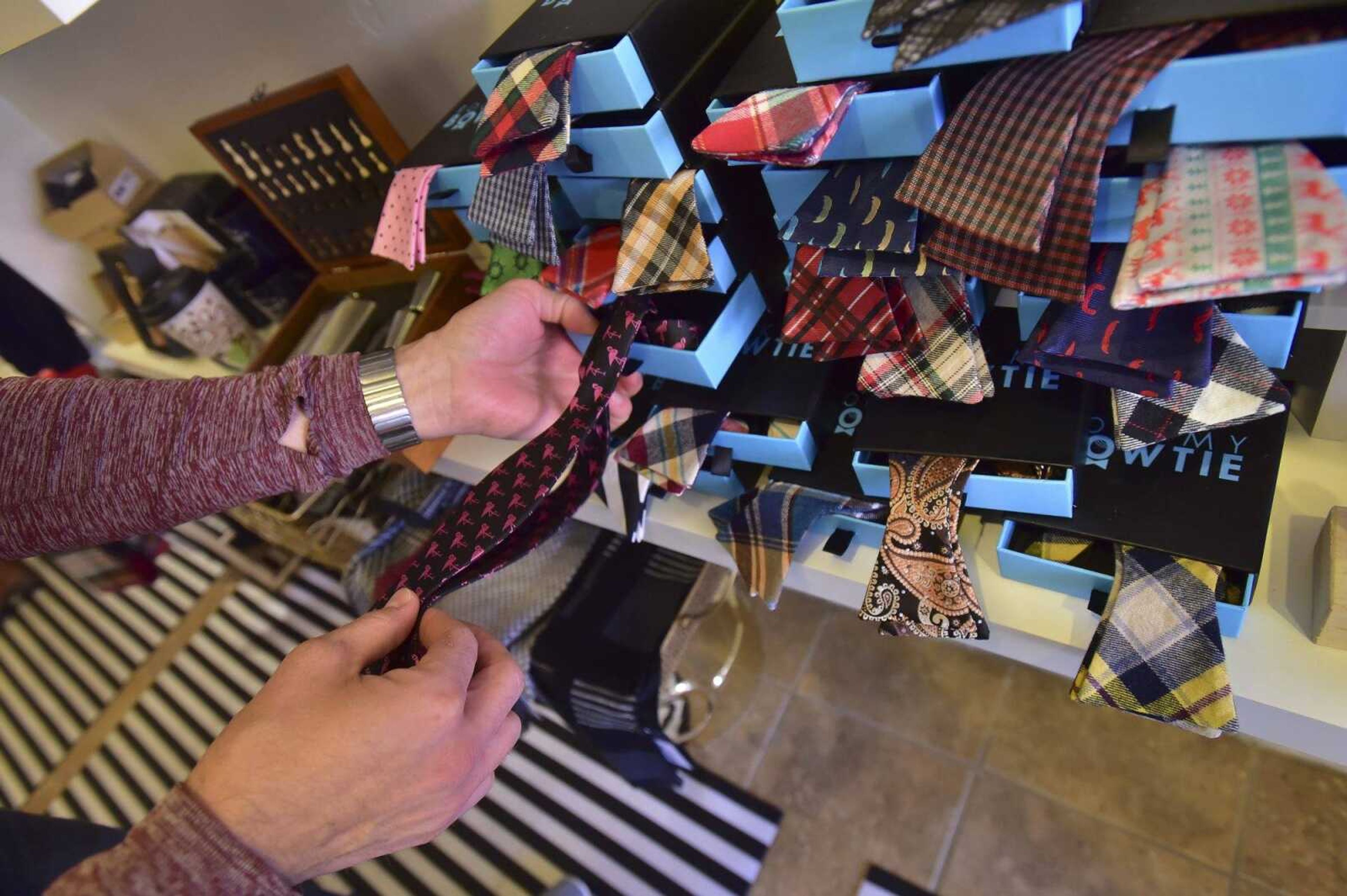 Michael Ornburn,picks up a flamingo bow tie while shopping at Atelier Tuesday in downtown Cape Girardeau.