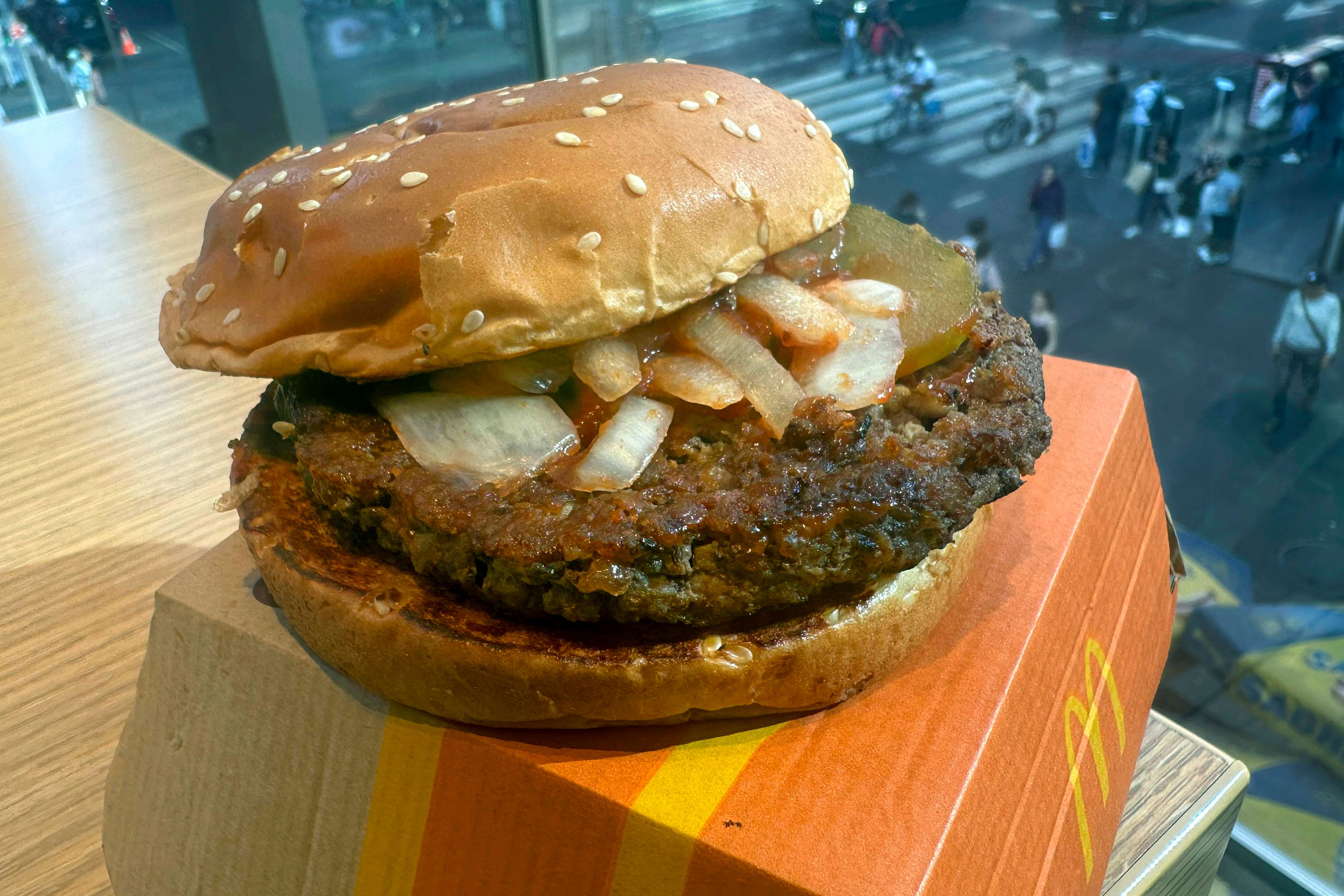 A McDonald's Quarter Pounder hamburger is shown in this photograph, in New York's Times Square, Wednesday, Oct. 23, 2024. (AP Photo/Richard Drew)