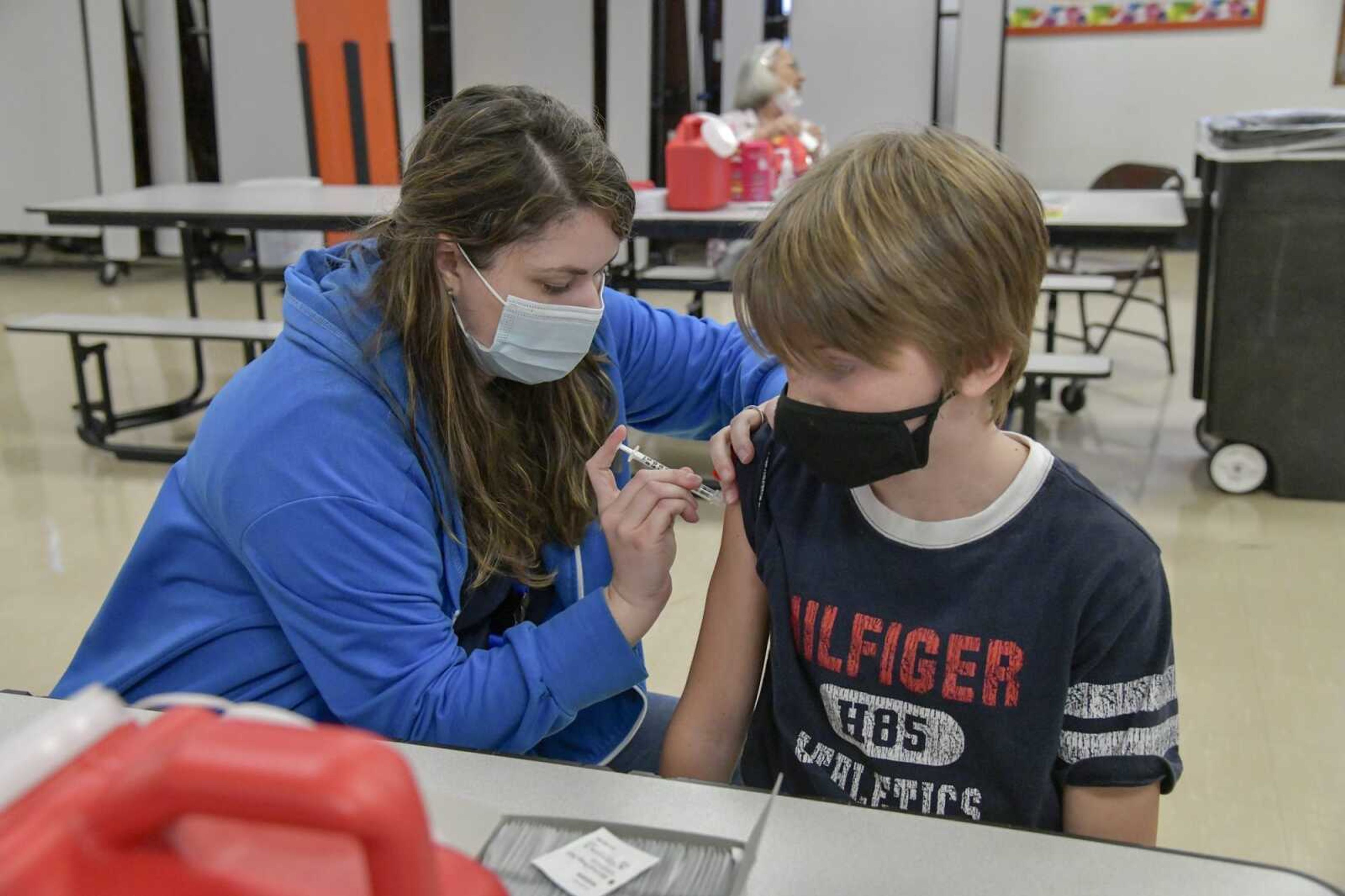 Beau Andrews, 11, receives his first dose of the COVID-19 vaccine during a clinic Thursday at Cape Girardau Central Middle School. "It felt like stepping on a sharp lego," he said afterward.