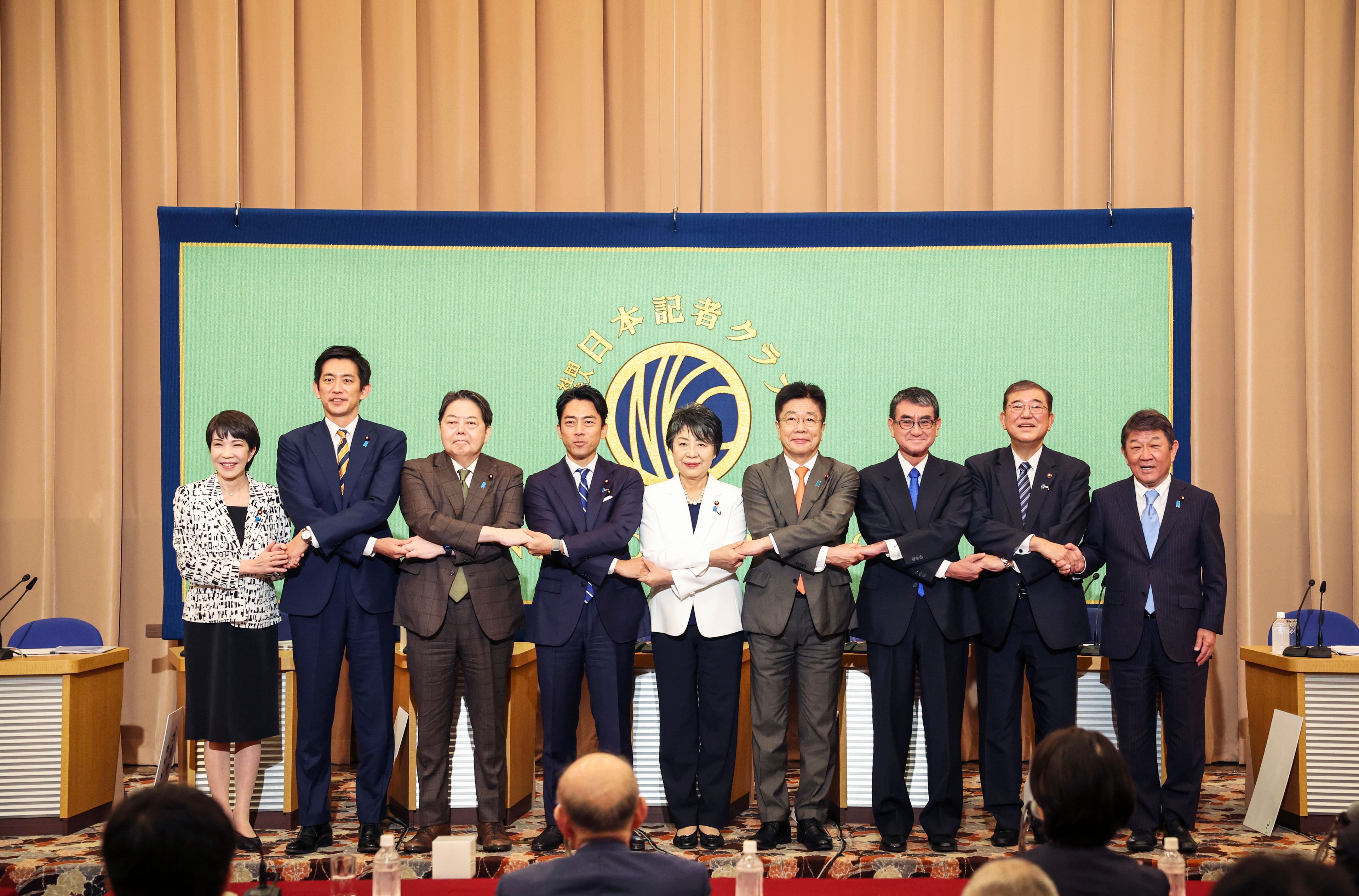 FILE - Candidates for Japan's ruling Liberal Democratic Party's (LDP) presidential election pose for a photo before a debate at the Japan National Press Club in Tokyo, on Sept. 14, 2024. From left are Economic Security Minister Sanae Takaichi, former Economic Security Minister Takayuki Kobayashi, Chief Cabinet Secretary Yoshimasa Hayashi, former Environment Minister Shinjiro Koizumi, Foreign Minister Yoko Kamikawa, former Chief Cabinet Secretary Katsunobu Kato, Digital Minister Taro Kono, former Defense Minister Shigeru Ishiba and Liberal Democratic Party Secretary General Toshimitsu Motegi. (Takashi Aoyama/Pool Photo via AP, File)