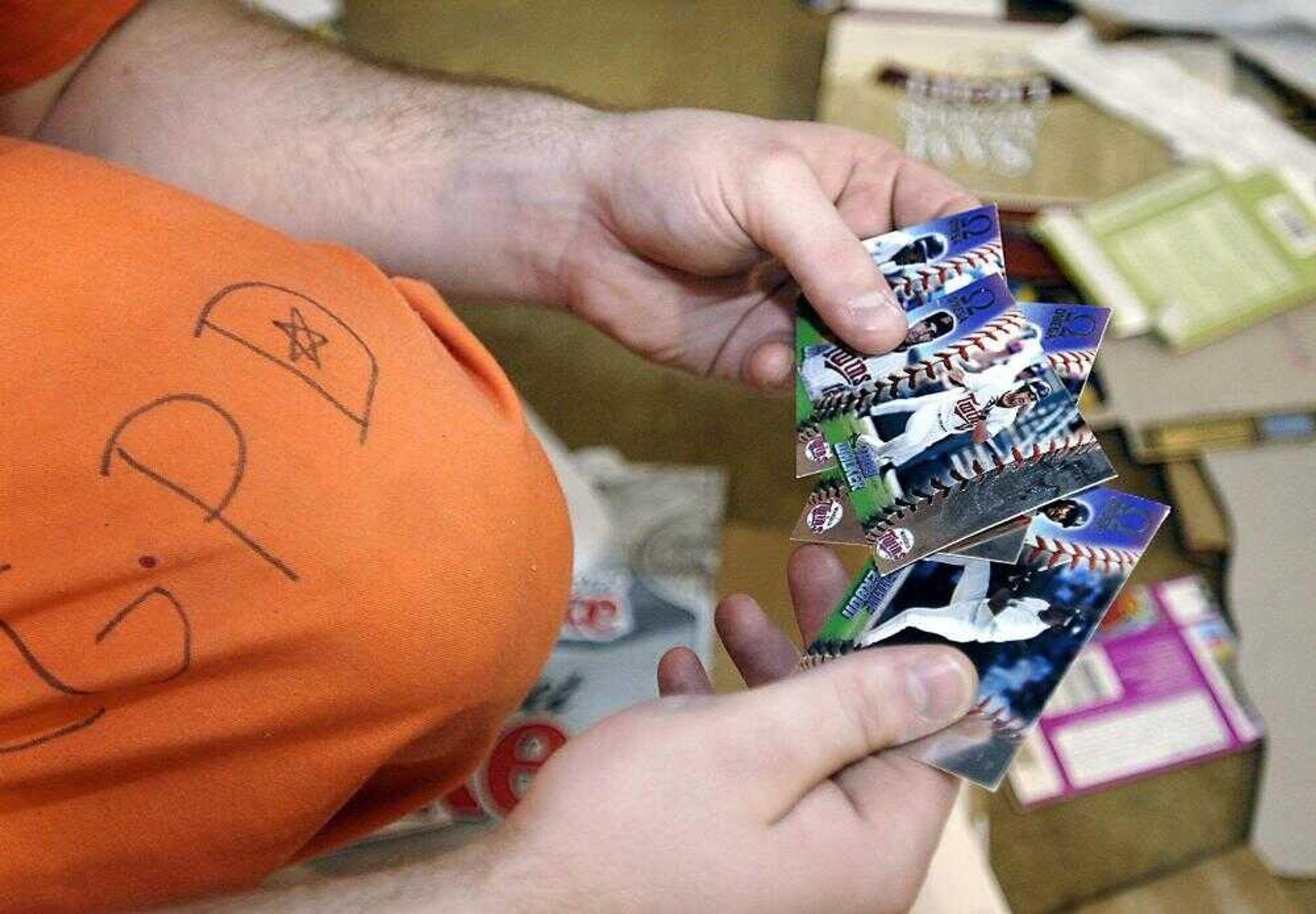 Cape Girardeau City Jail inmate Matt Loyd glanced through baseball cards he found while sorting cardboard Friday at the Cape Girardeau Recycling Center.