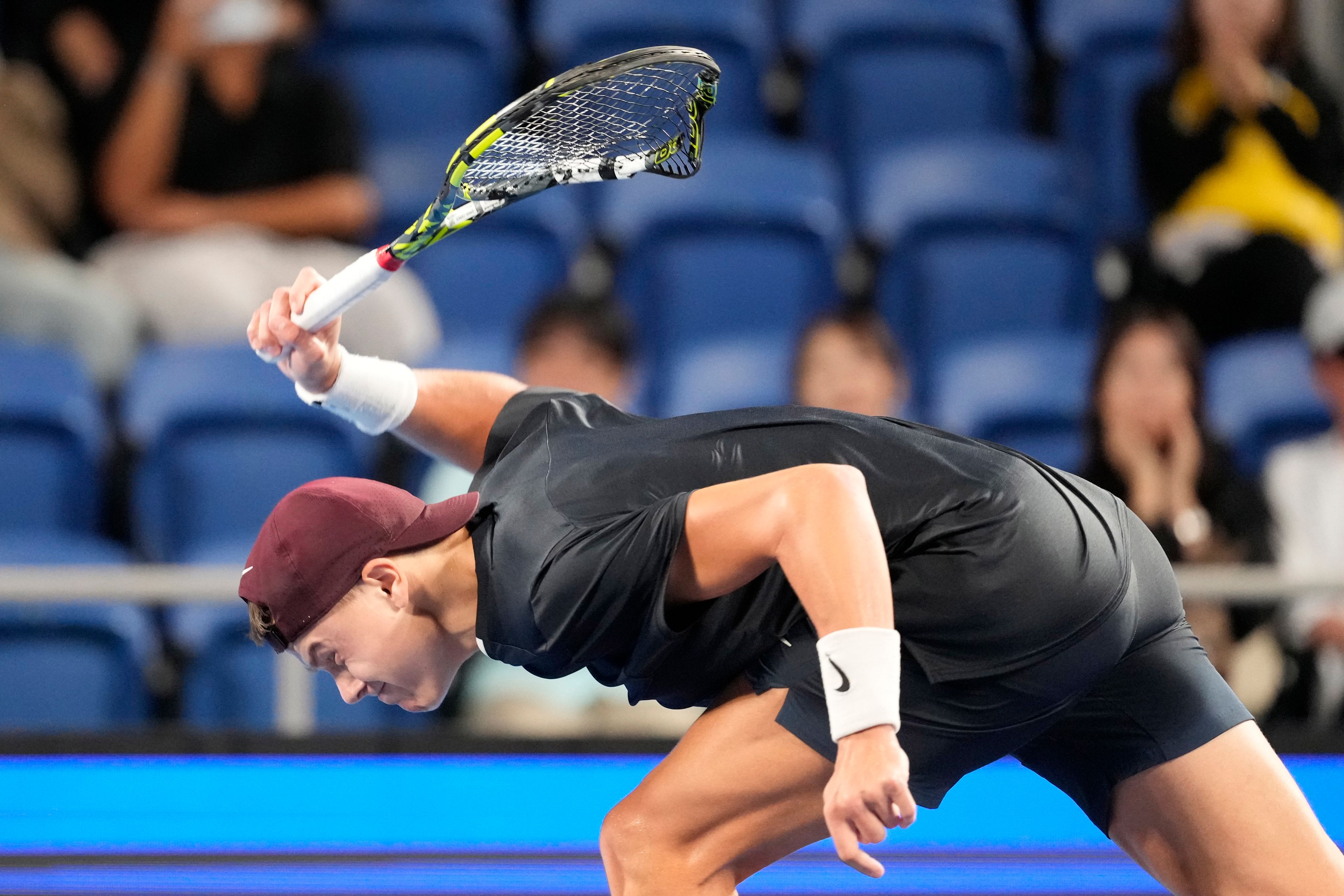 Holger Rune of Denmark smashes his racket in frustration during his men's singles semifinal match against Arthur Fils of France at the Japan Open tennis tournament on Monday, Sept. 30, 2024, at Ariake Colosseum, in Tokyo, Japan. (AP Photo/Eugene Hoshiko)