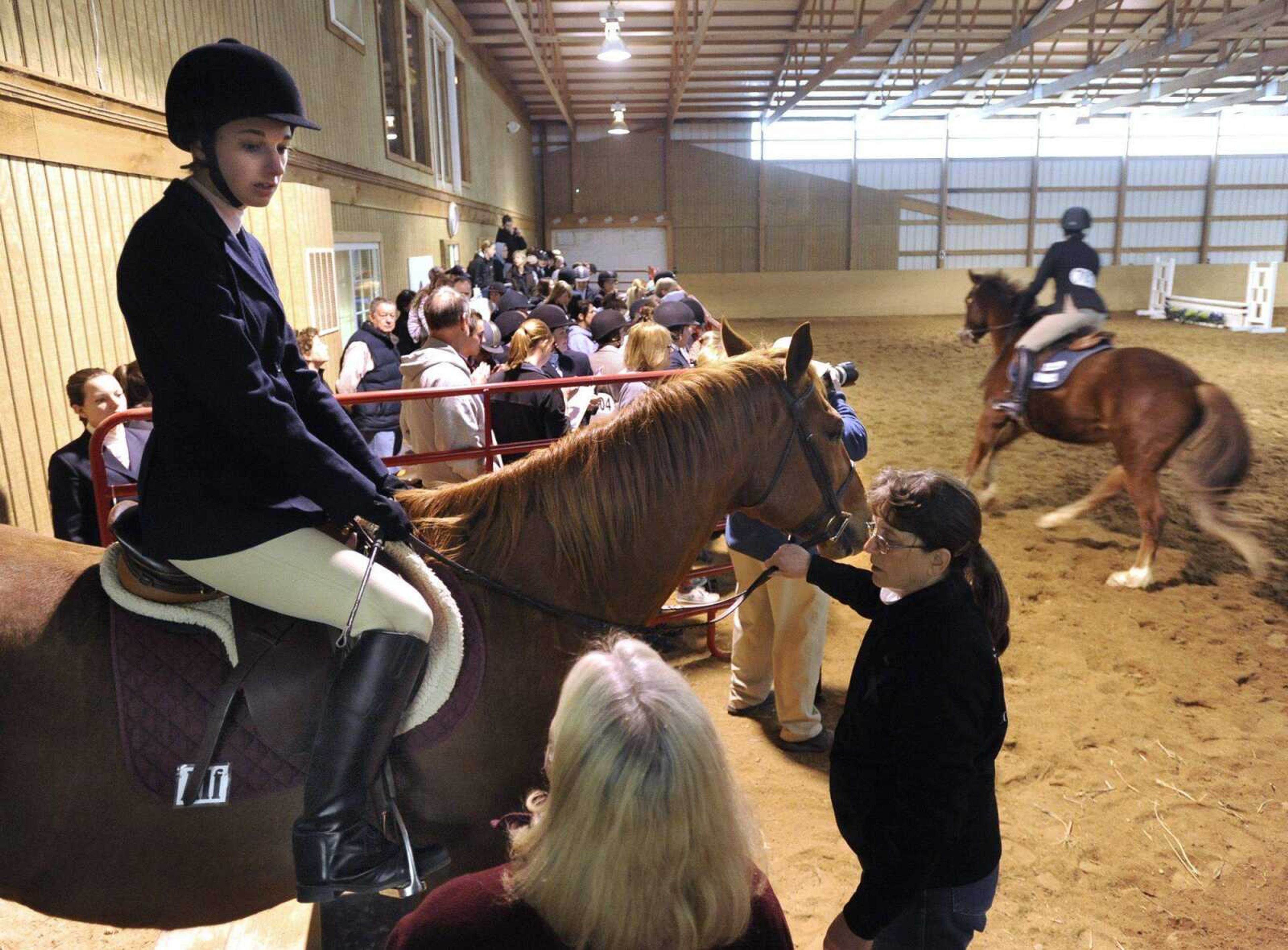 Alex Wolf, a member of the equestrian team at Southeast Missouri State University, prepares to ride Alf in the novice fences event of its first-ever home meet Sunday at Fox Run Stables. (Fred Lynch)