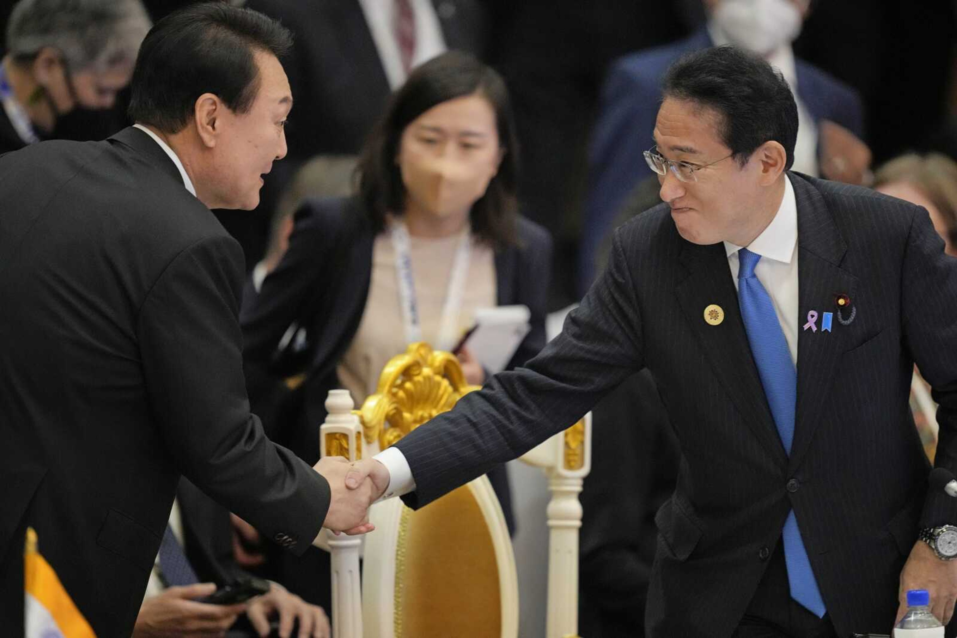 Japan's Prime Minister Fumio Kishida, right, shake hand with South Korea's President Yoon Suk Yeol during the ASEAN-East Asia Summit on Sunday, Nov. 13, in Phnom Penh, Cambodia.