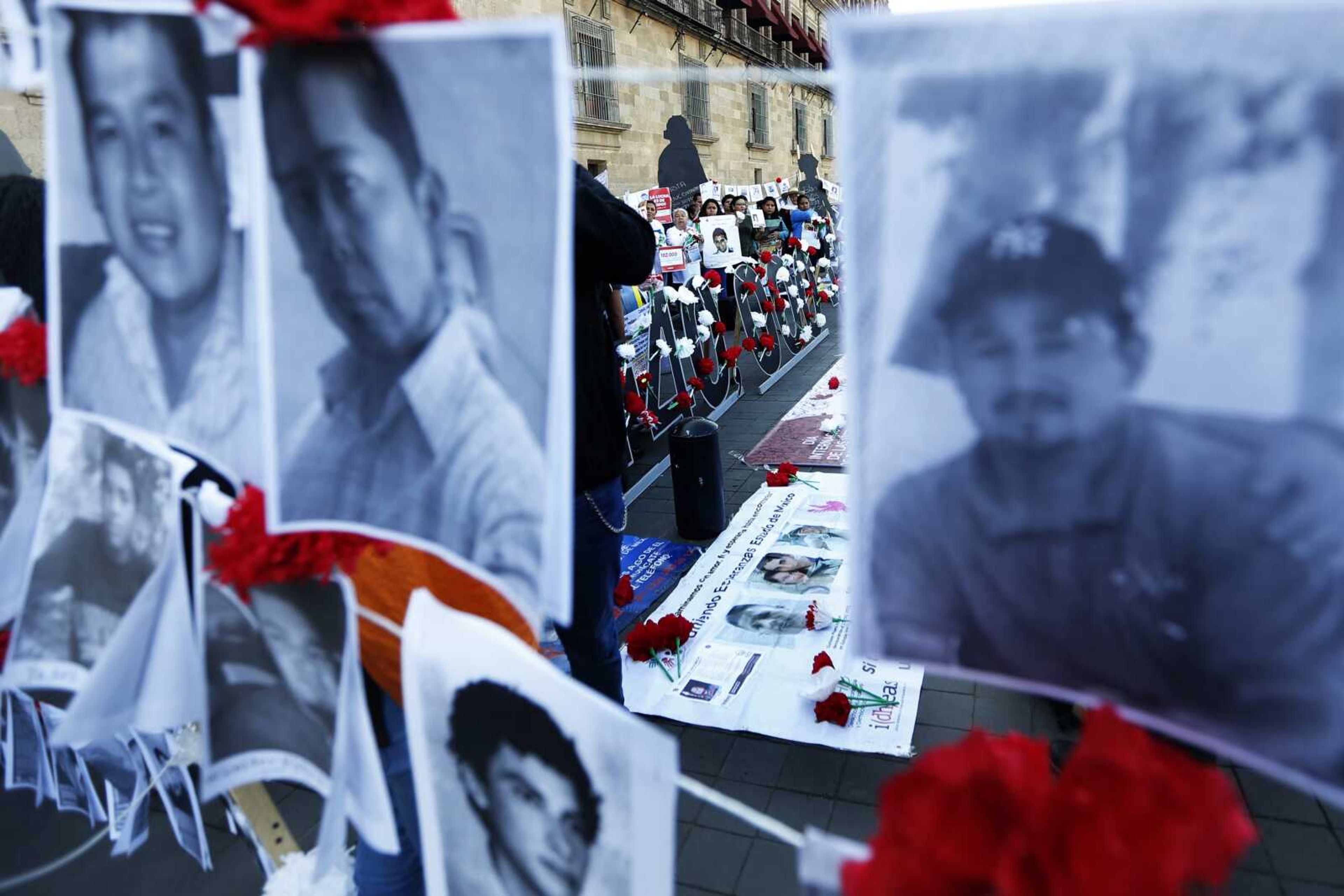 Relatives of the disappeared protest in front of the National Palace in Mexico City, Mexico, Friday, Aug. 30, 2019. Demonstrators presented a petition with 102 thousand signatures to demand that the disappeared be found and identified. (AP Photo/Marco Ugarte)