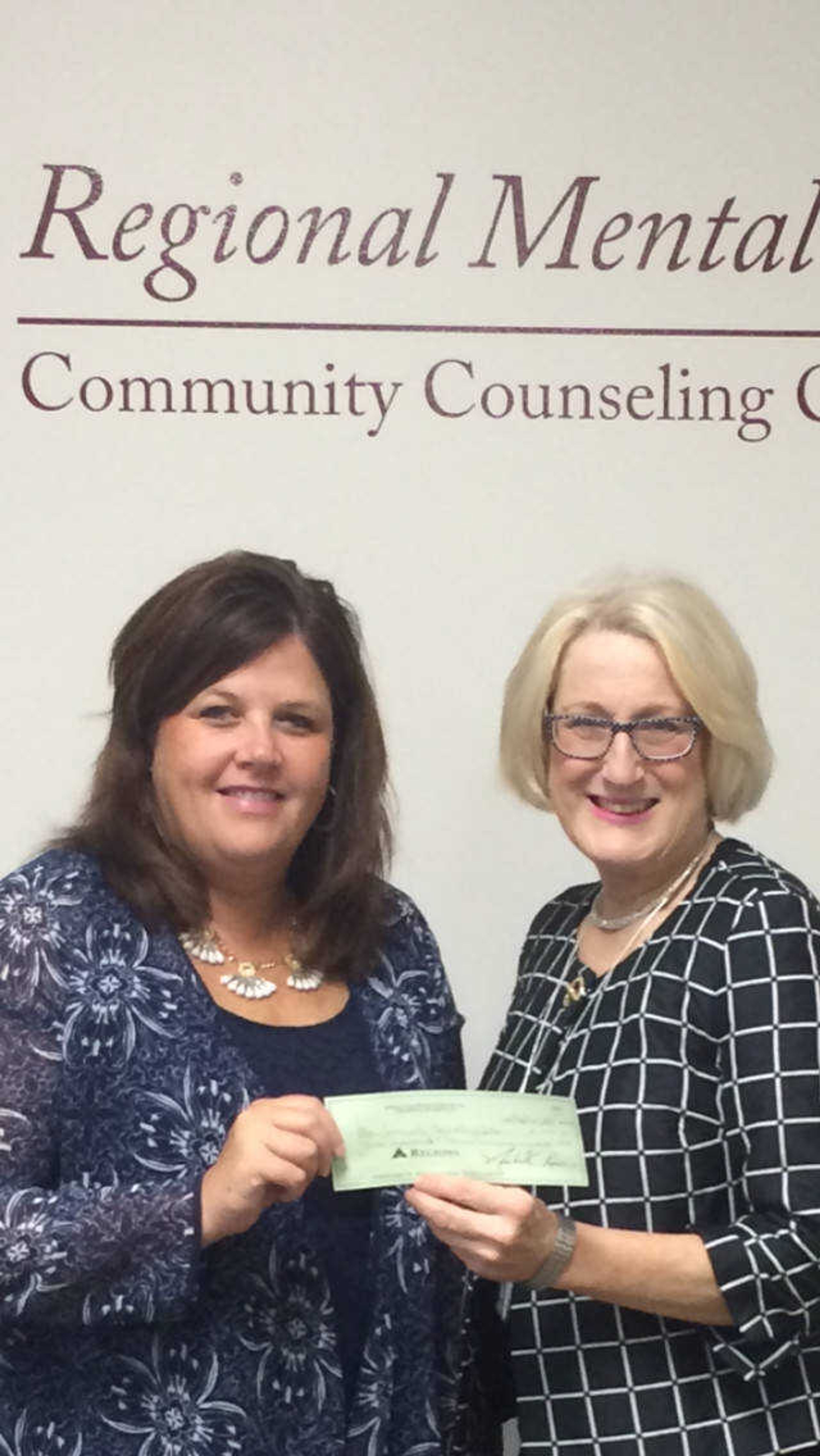 Presenting check on RMHC behalf is Cheryl Farrow, Director of Operations for McDonalds and accepting check is Mary Burton, with Cottonwood Residential Treatment Facility