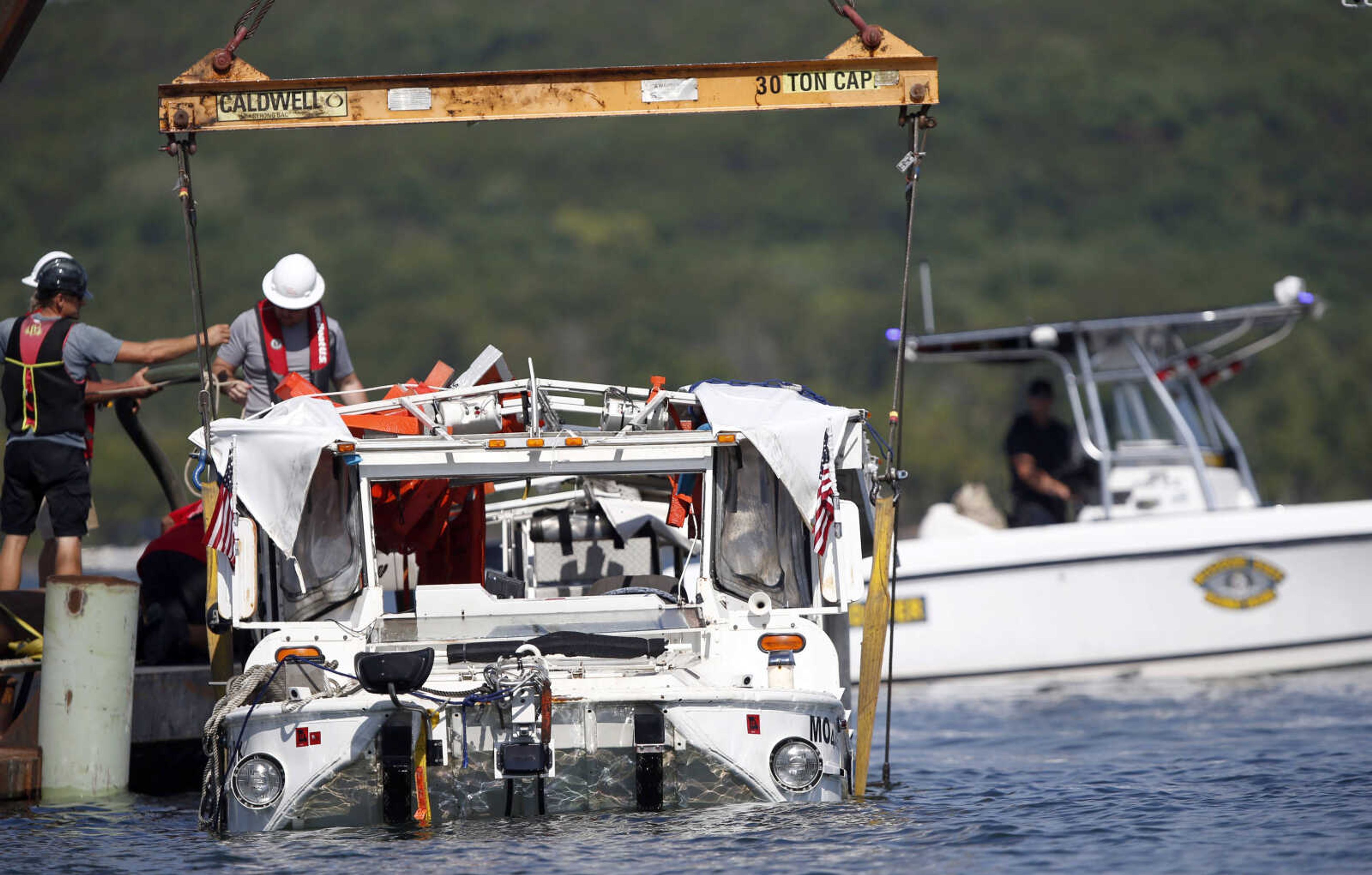 The duck boat that sank in Table Rock Lake in Branson, Missouri, is raised Monday.