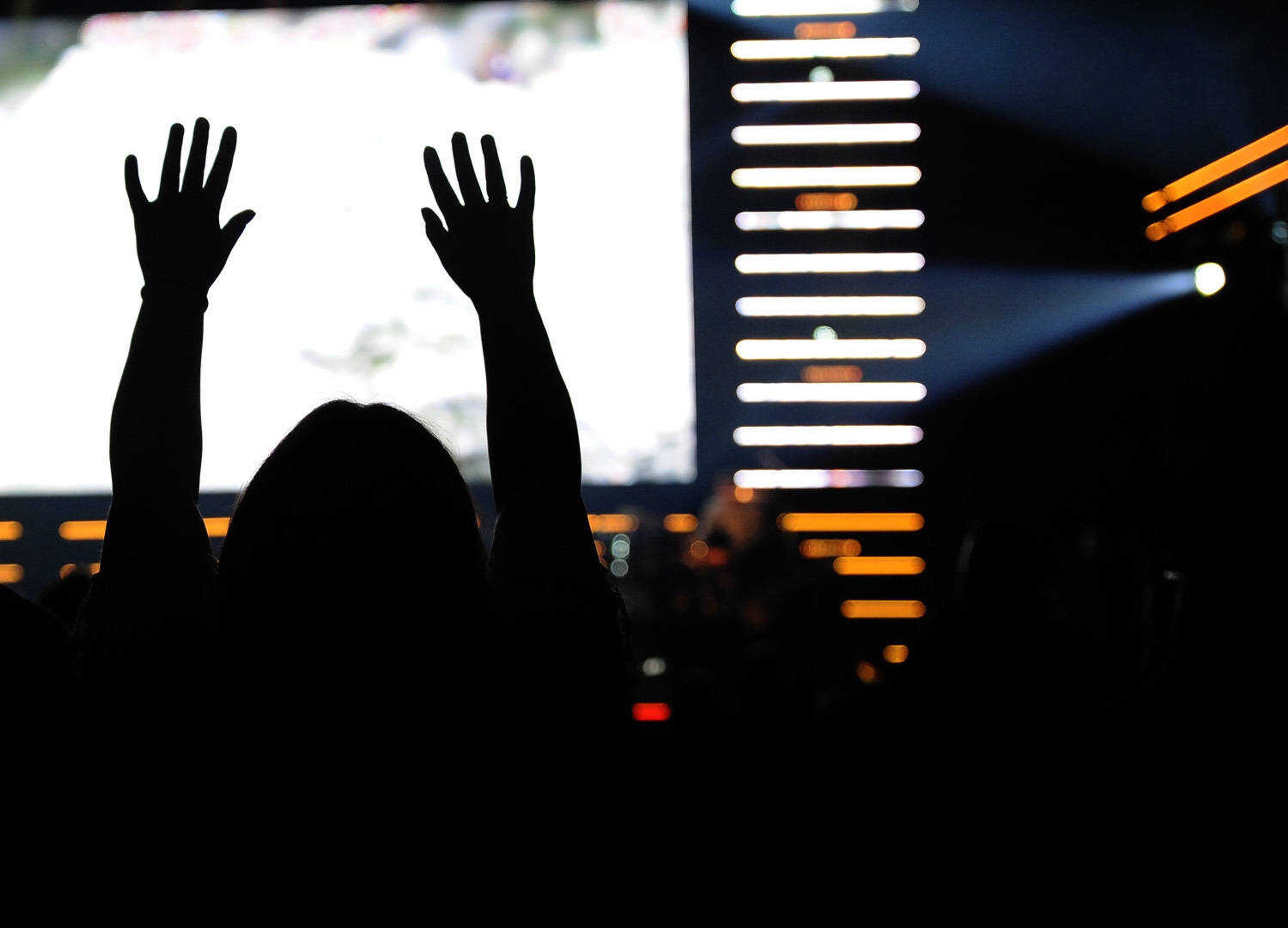 A concert goer raises her arms in response to the music of The Roadshow on Thursday, Feb. 22, 2018, held at the Show Me Center in Cape Girardeau.