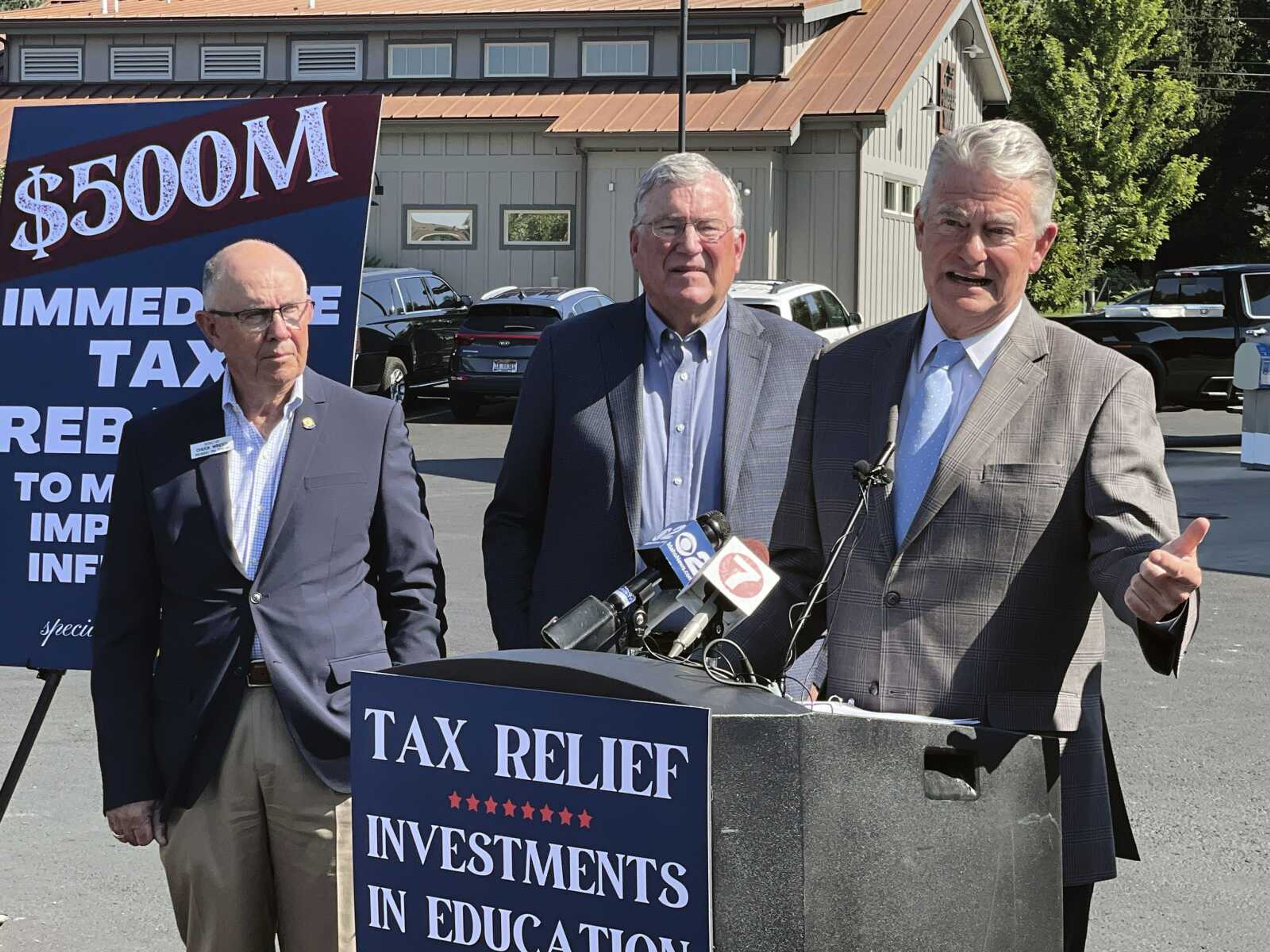 FILE - Republican Gov. Brad Little, right, announces a special session of the Legislature for a proposed $500 million tax rebate and $410 million in education spending to deal with inflation as Republican House Speaker Scott Bedke, center, and Republican Senate President Pro-Tem Chuck Winder, left, look on, Tuesday, Aug. 23, 2022, in Boise, Idaho. State governments flush with money are returning billions of dollars to their residents. Already this year, at least 31 states have enacted some form of tax cut or rebate. (AP Photo/Keith Ridler, File)