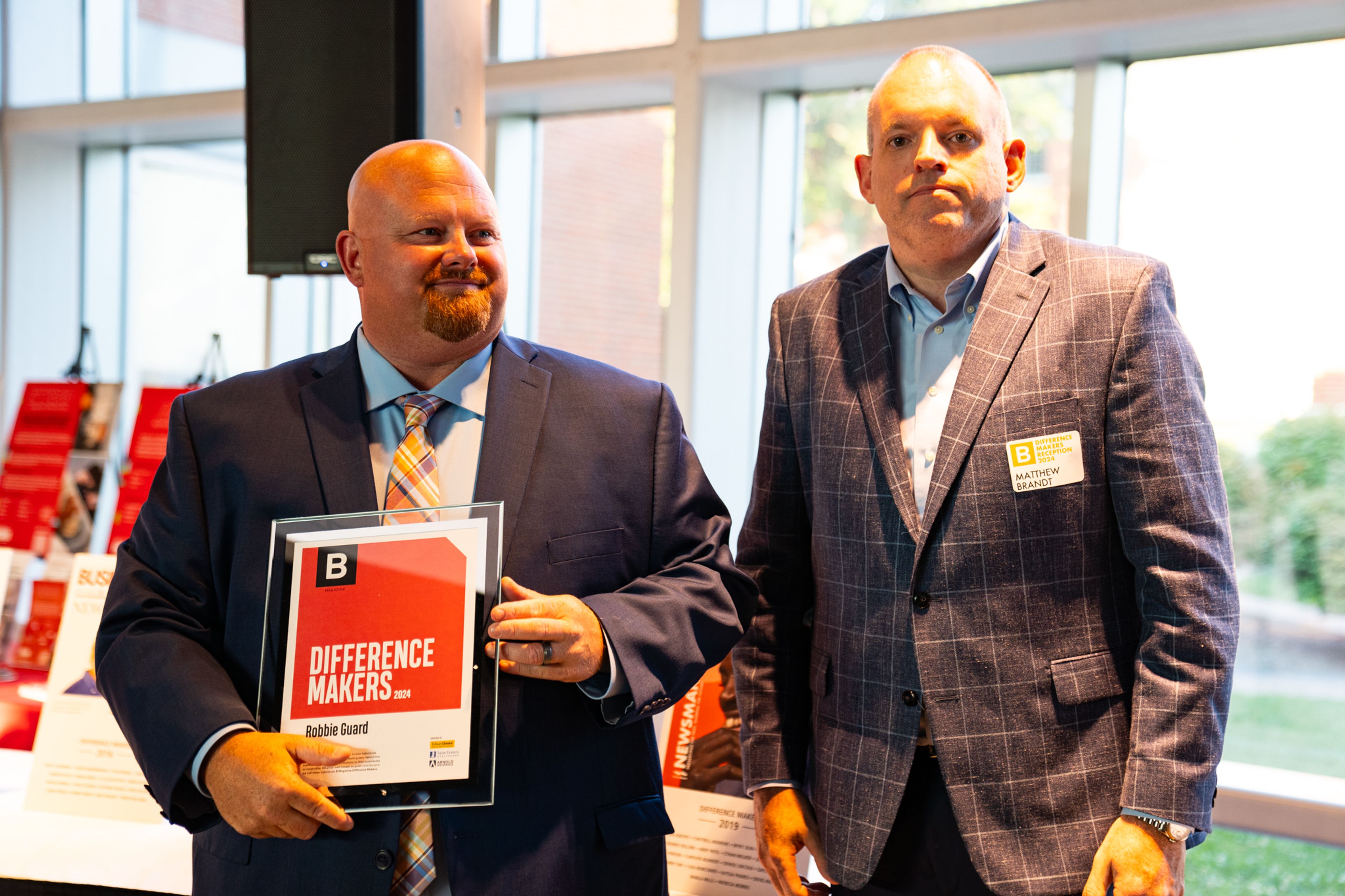 Robbie Guard receives a plaque from Saint Francis Healthcare System’s Matthew Brandt recognizing him as a 2024 Difference Maker at their reception at Southeast Missouri State University’s River Campus. The Difference Maker’s reception was presented by B Magazine on Thursday, Sept. 6.