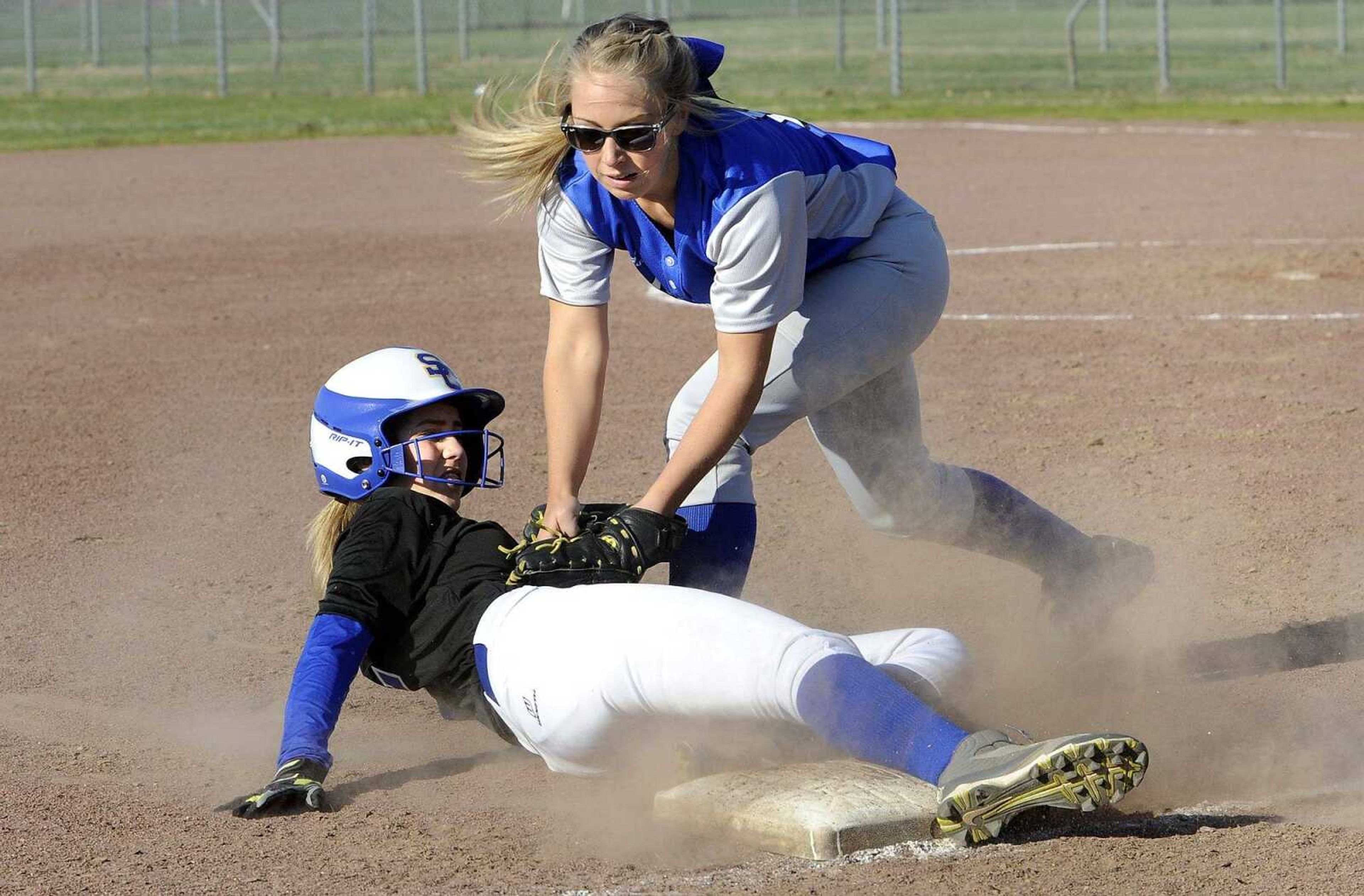 Scott City's Diamond Ham slides safely into third base as Oran shortstop Sydney Kern covers on the play during the third inning Monday, March 21, 2016 in Scott City.