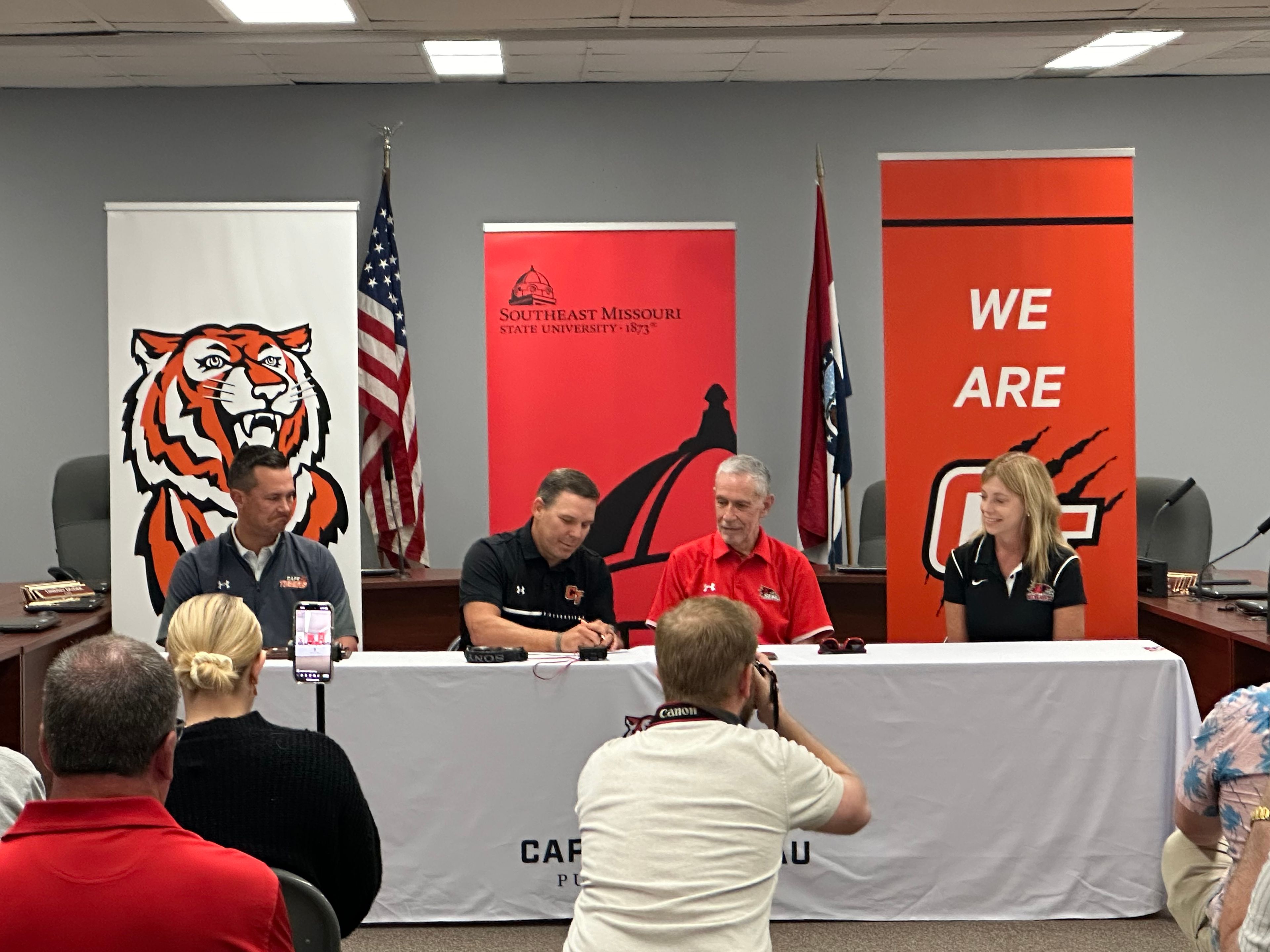 Cape Girardeau Public Schools superintendent Dr. Howard Benyon, middle left, and Southeast Missouri State University president Carlos Vargas, middle right, sign an agreement Thursday, Aug. 8, at the Cape Public Schools Administration Office while the district’s deputy superintendent for K-12 education Dr. Brice Beck, far left, and SEMO’s vice president of Enrollment Management and Student Success Dr. Debbie Below look on. 