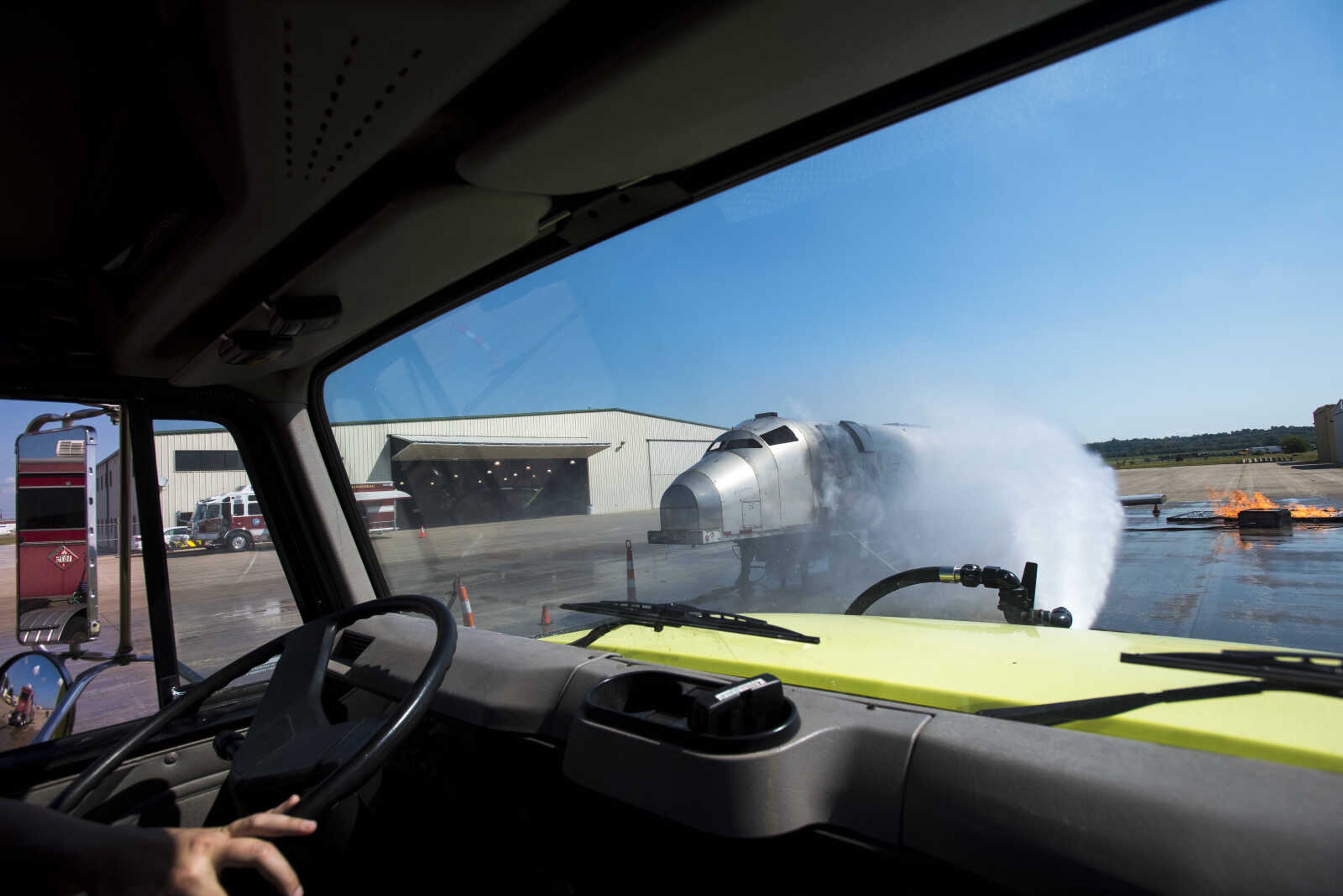 Kelly Mitchell with the Cape Girardeau Fire Department runs an airplane fire drill at the Cape Girardeau Regional Airport Friday morning, Sept. 15, 2017 in Cape Girardeau.