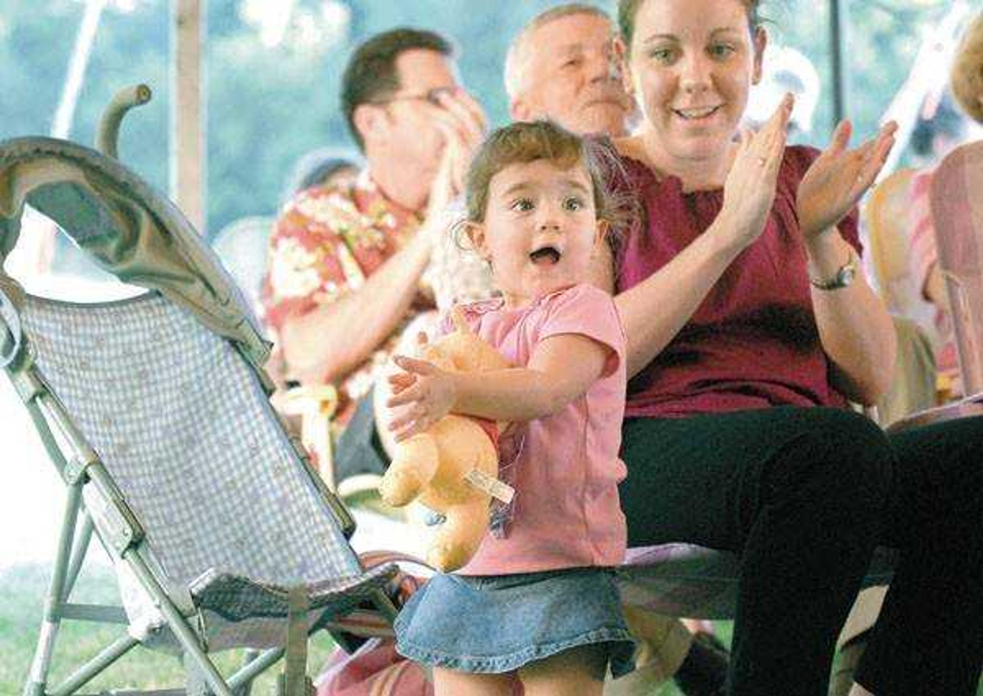 Lauren Lamar, 2, was more than happy with the performance of the Cape Municipal Band. Lauren is the daughter of Rebecca, right, and Josh Lamar of Cape Girardeau.