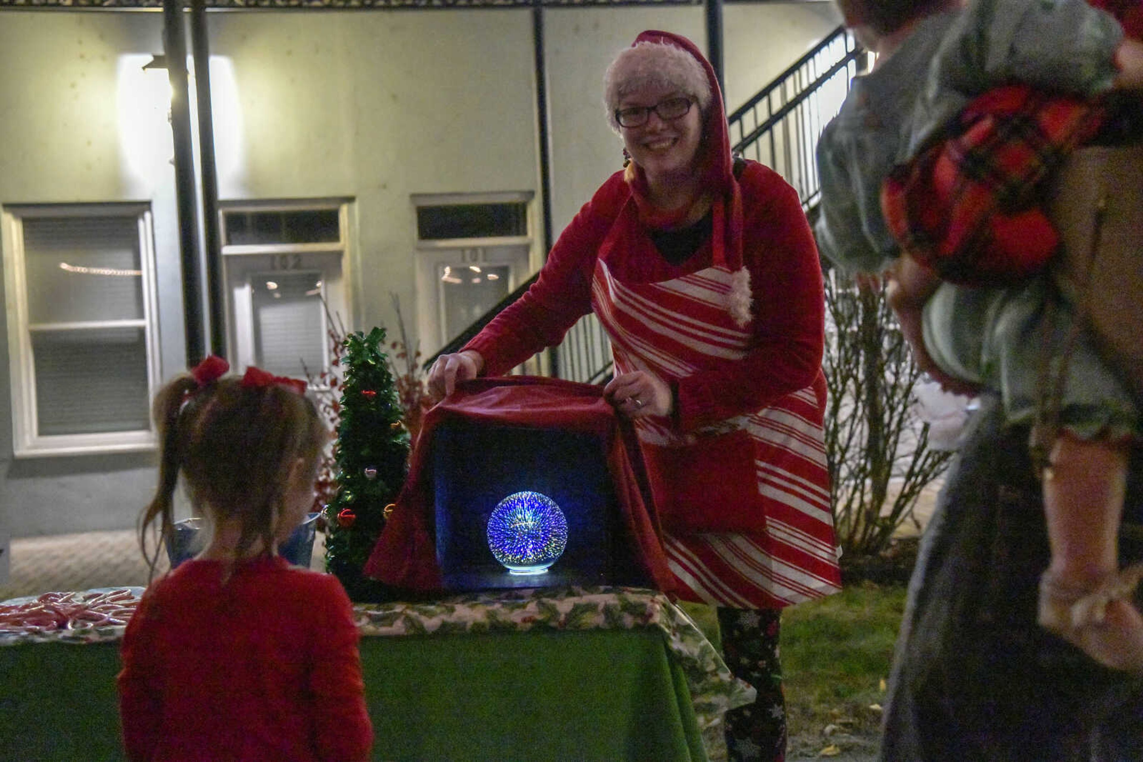 Amanda Pennington shows visitors the magic of Christmas at Santa's Workshop by Discovery Playhouse during the Annual Downtown Holiday Open House on Friday in Cape Girardeau.