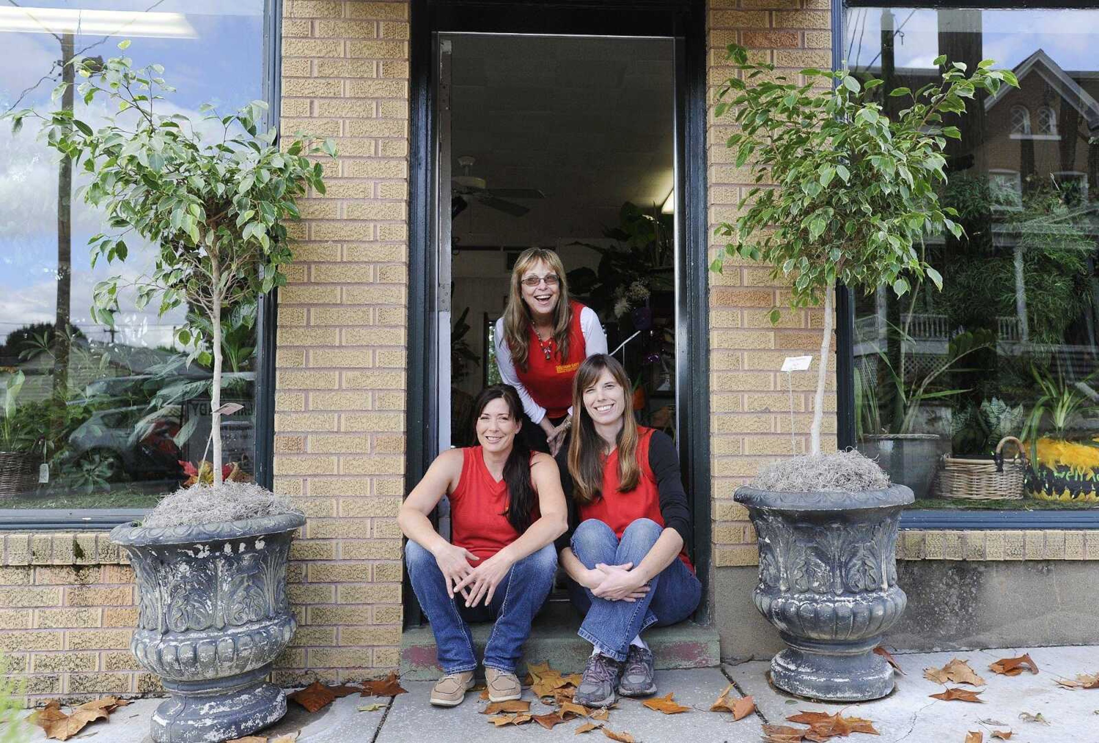 Christy Smith, left, Beth Preston, center, and Casey Zimmerman, pose for a photo outside The Plant Lady in downtown Cape Girardeau. (Laura Simon)