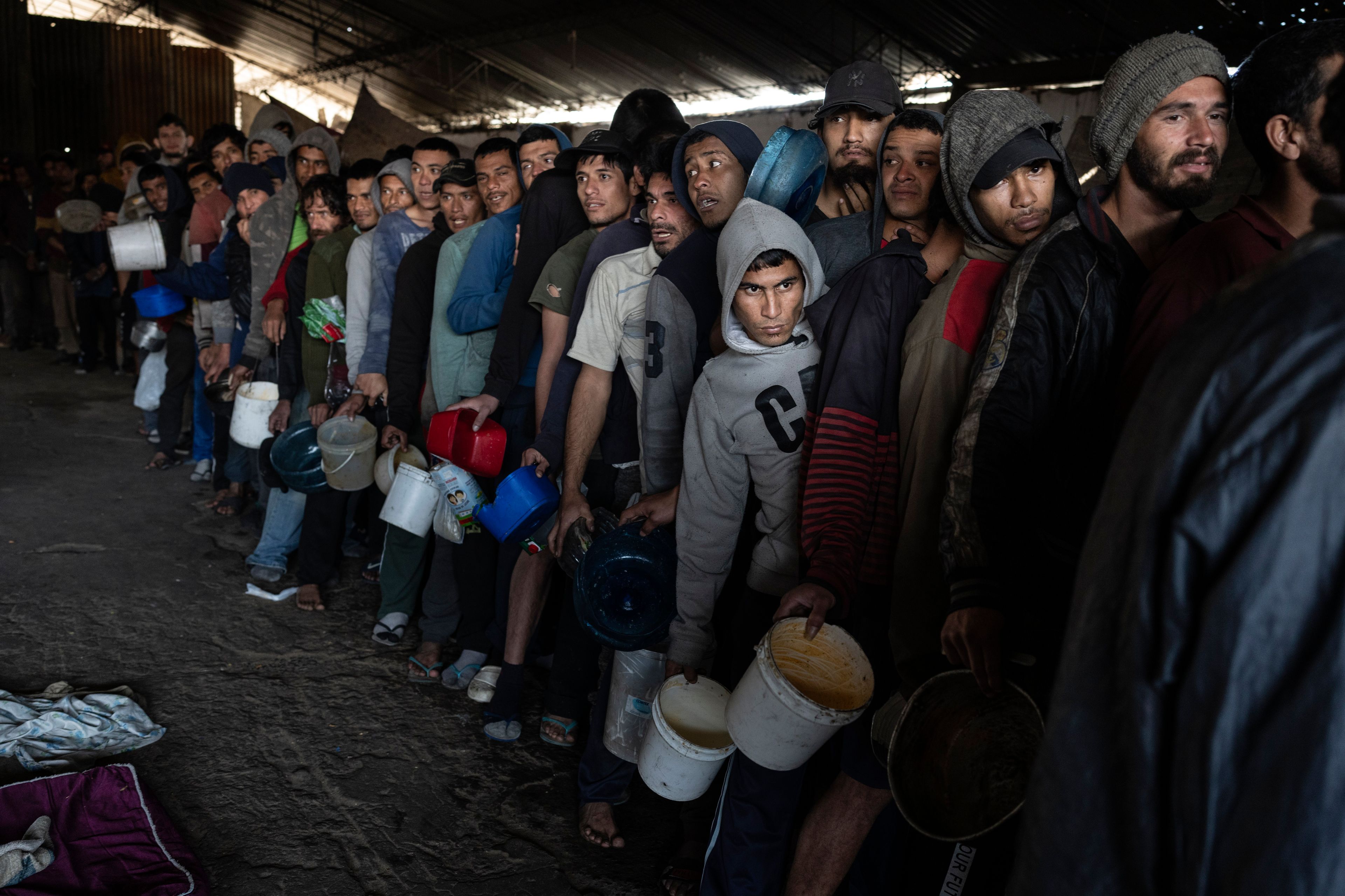 Prisoners line up for a jail-provided meal known as "vori-vori" at the Tacumbu prison in Asuncion, Paraguay, Wednesday, July 10, 2024. The soup, made of chicken or beef, vegetables, and corn balls stuffed with cheese, is considered the food of the poorest inmates, and those who can afford it prefer to buy other food. (AP Photo/Rodrigo Abd)