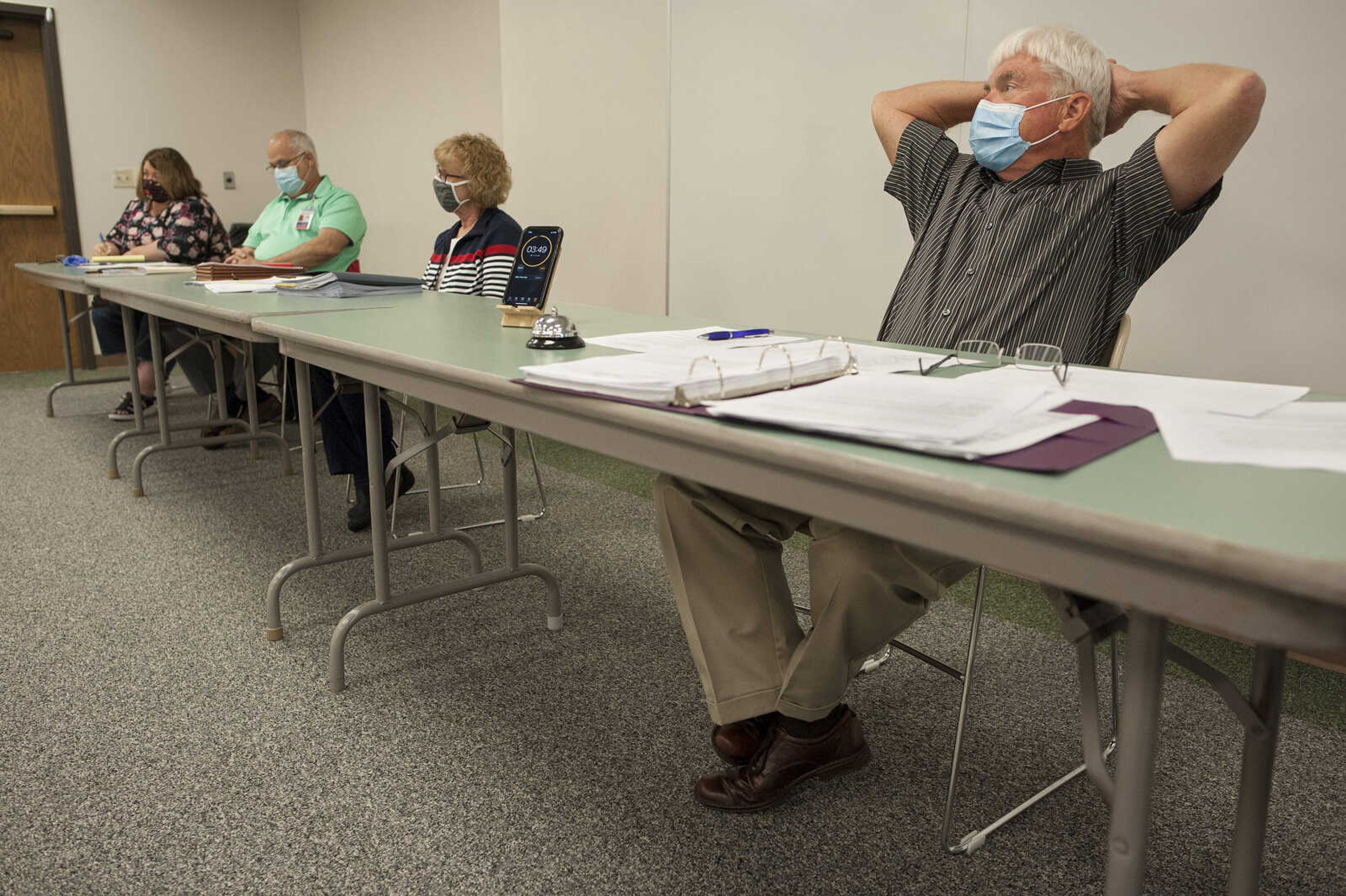 After setting a timer, Cape Girardeau County Public Health Center board member John Freeze leans back to listen to a citizen Tuesday, July 28, 2020, at the Osage Centre in Cape Girardeau.