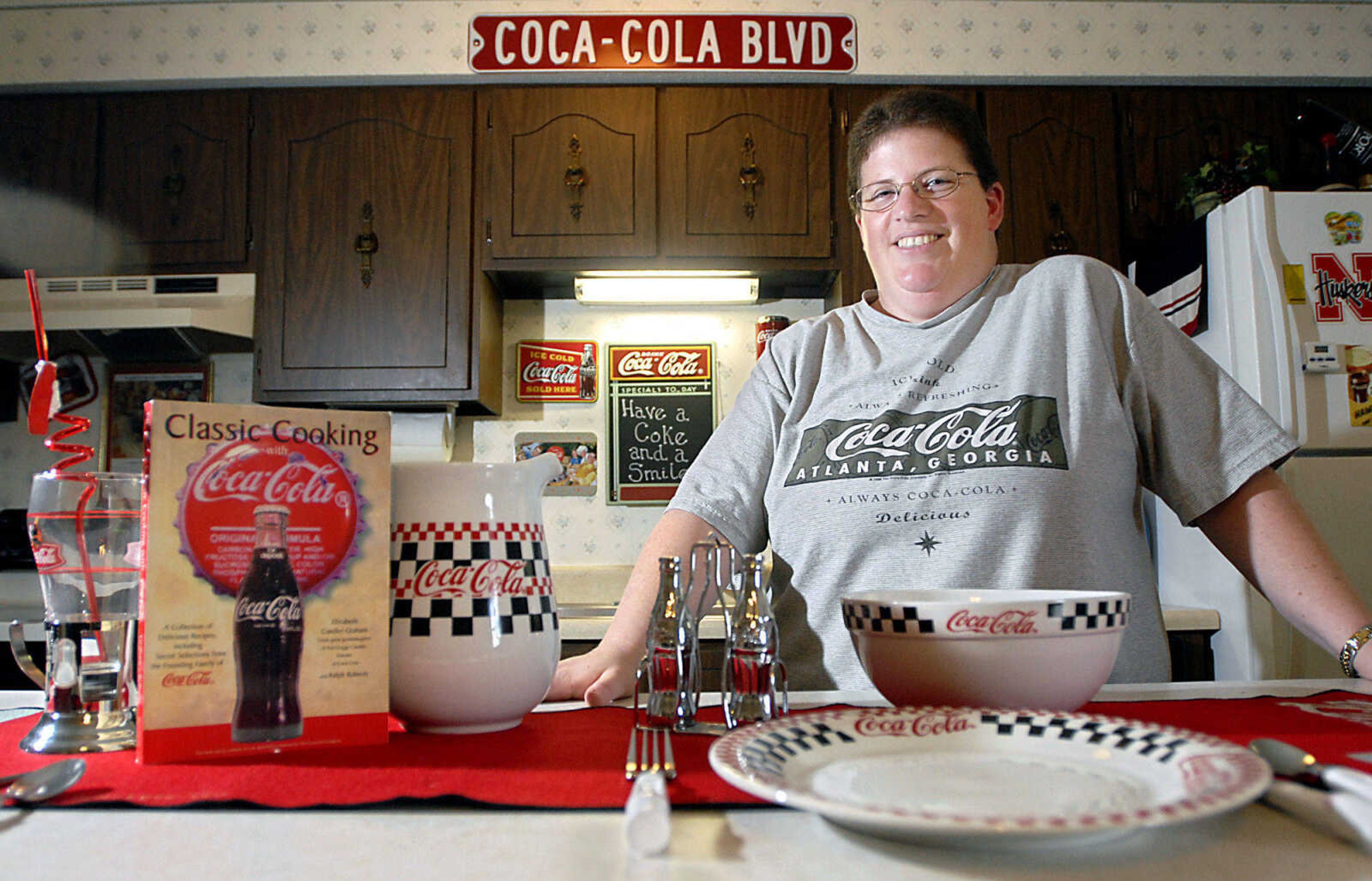 KIT DOYLE ~ kdoyle@semissourian.com
Collector Leah Kortmeyer in her Cape Girardeau kitchen Wednesday, August 19, 2009, with a few of her many Coca-Cola memorabilia items.