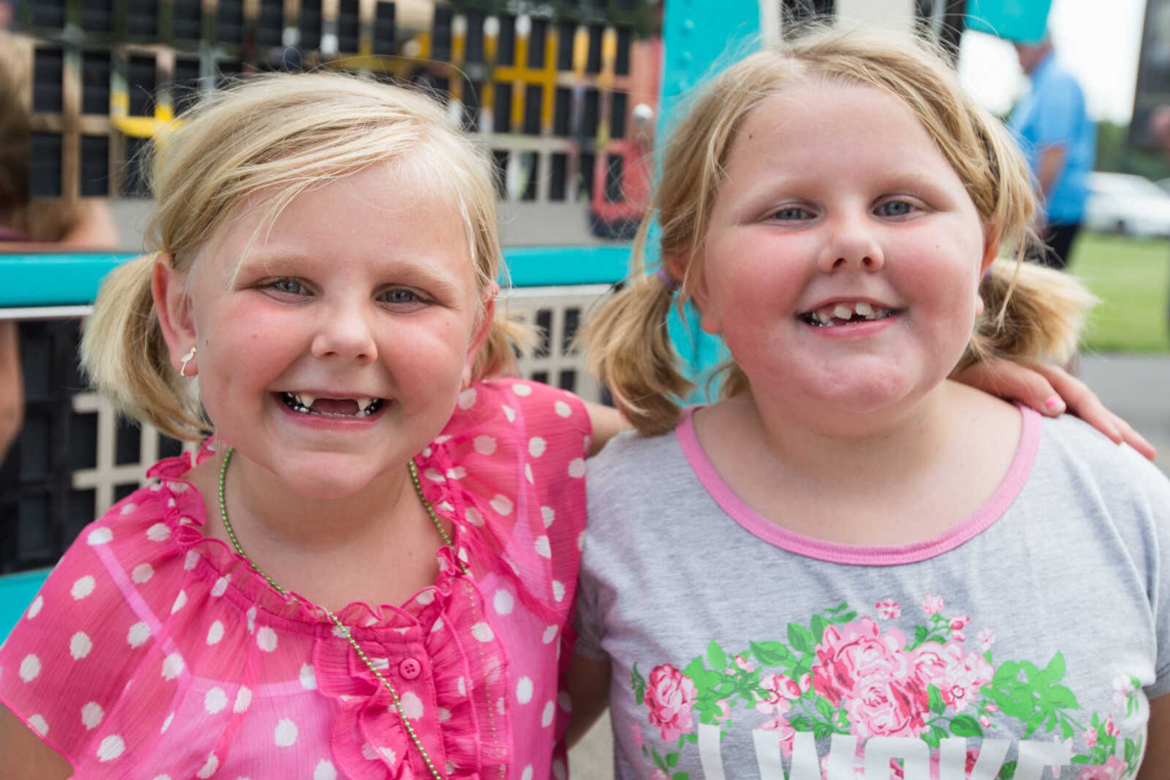 GLENN LANDBERG ~ glandberg@semissourian.com

Hollie and Emma Aslinger pose for a photo during the Rev'n Rods & Heartland Music Tour stop at Arena Park Tuesday, July 19, 2016 in Cape Girardeau.