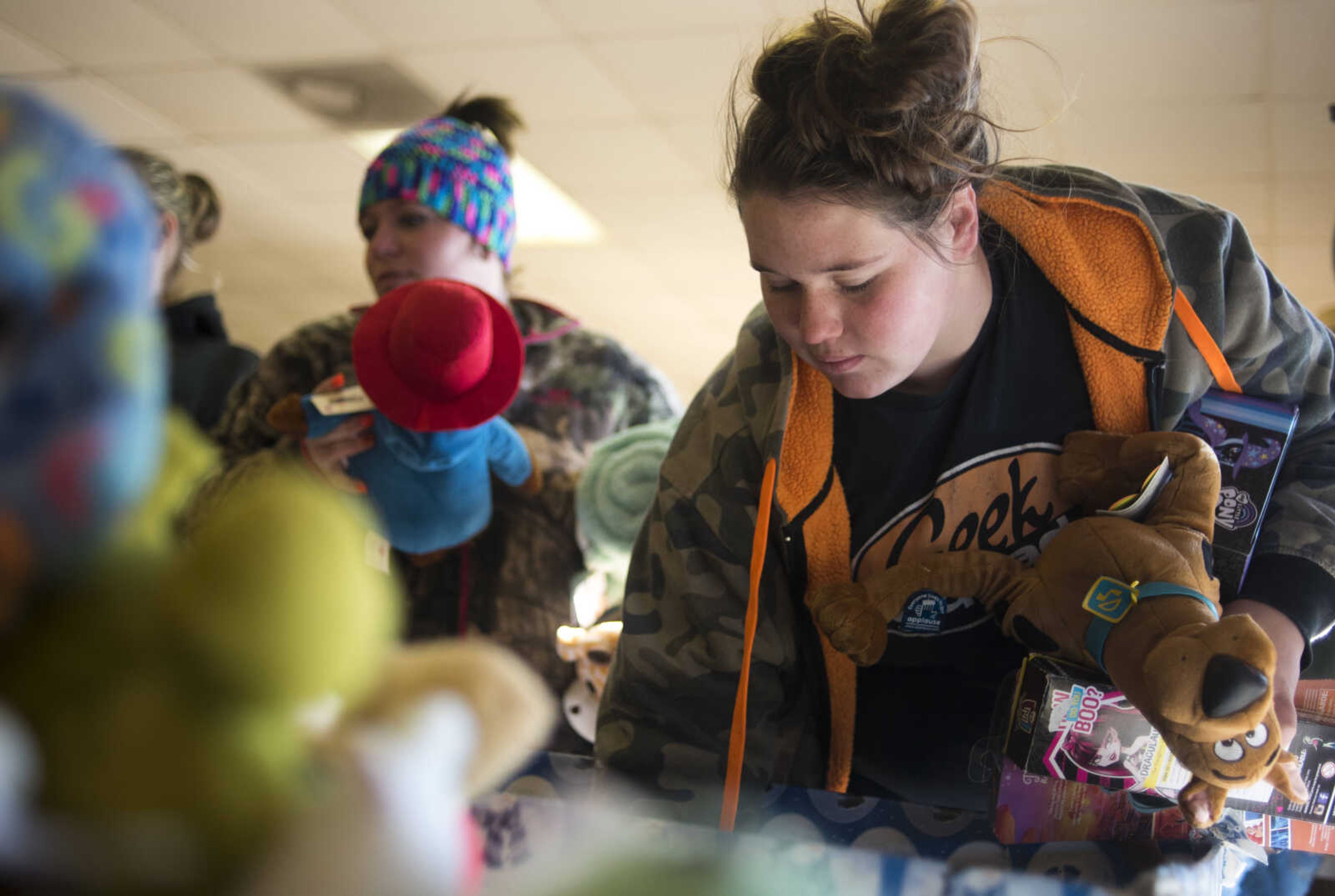 Clarissa Kimbel picks out toys for her children Friday, Dec. 15, 2017, at Elks Lodge #2652 in Jackson.