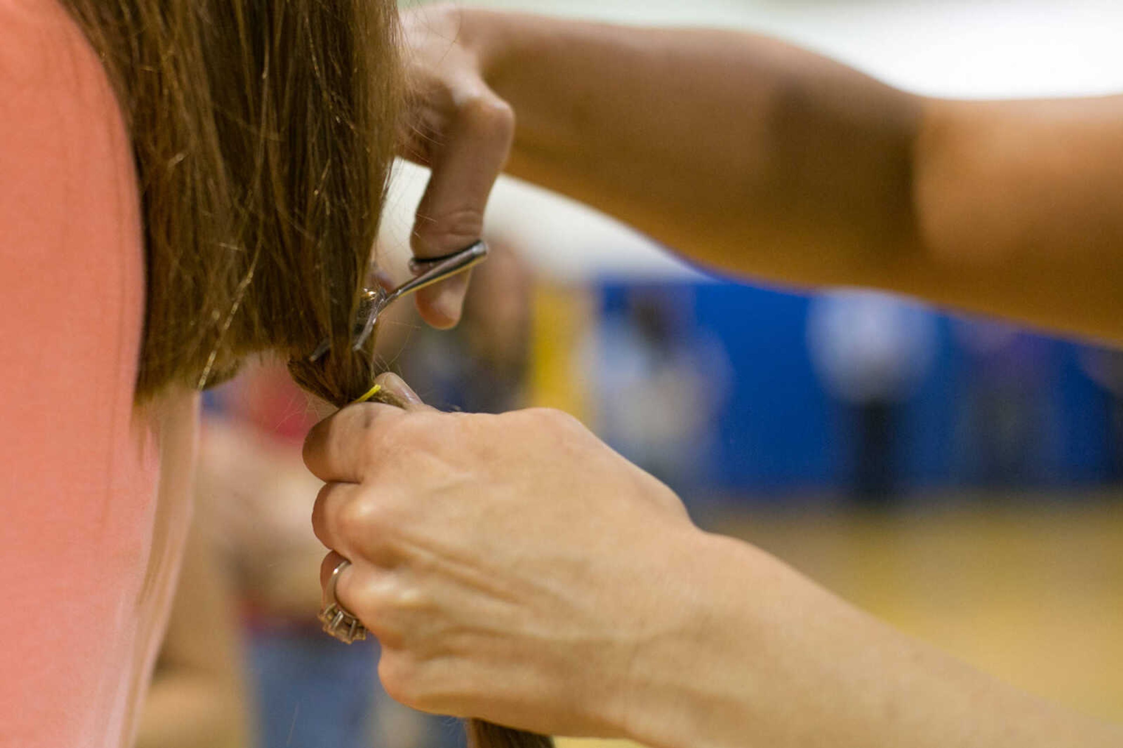 GLENN LANDBERG ~ glandberg@semissourian.com

Hair is cut and donated to the Beautiful Lengths program Monday, May 18, 2015 at Scott City High School. Twenty-four students and teachers participated in the event that provides wigs to cancer patients across the country.