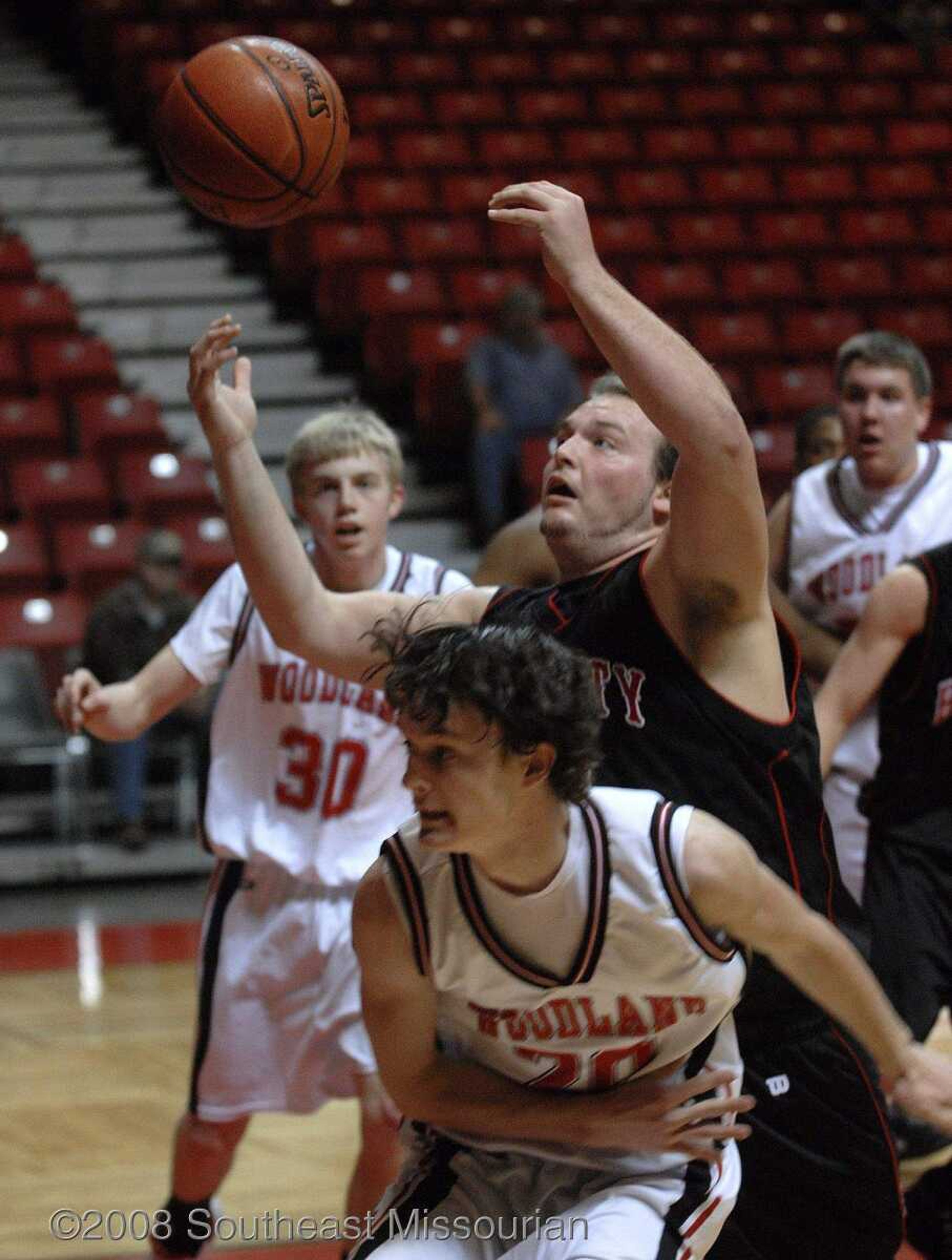 FRED LYNCH ~ flynch@semissourian.com
Bell City's John Arnold looks to grab a rebound against Woodland during the first quarter in Southeast Missourian Christmas Tournament Saturday at the Show Me Center.