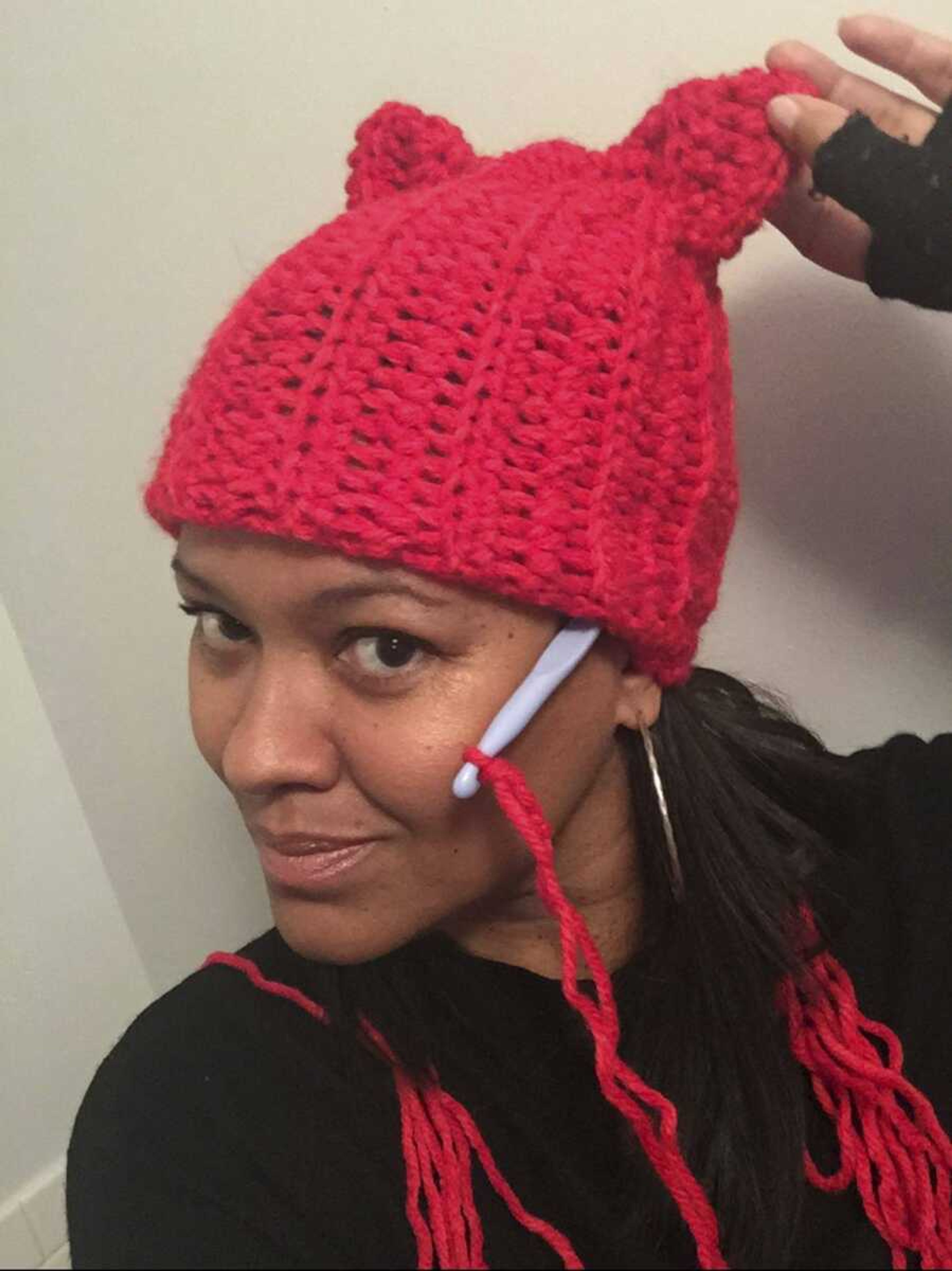 Crystal Howard of New York shows off the "pussy" hat she was making as part of a call to action answered by thousands of knitters to show solidarity with marchers at the Women's March in Washington, D.C.