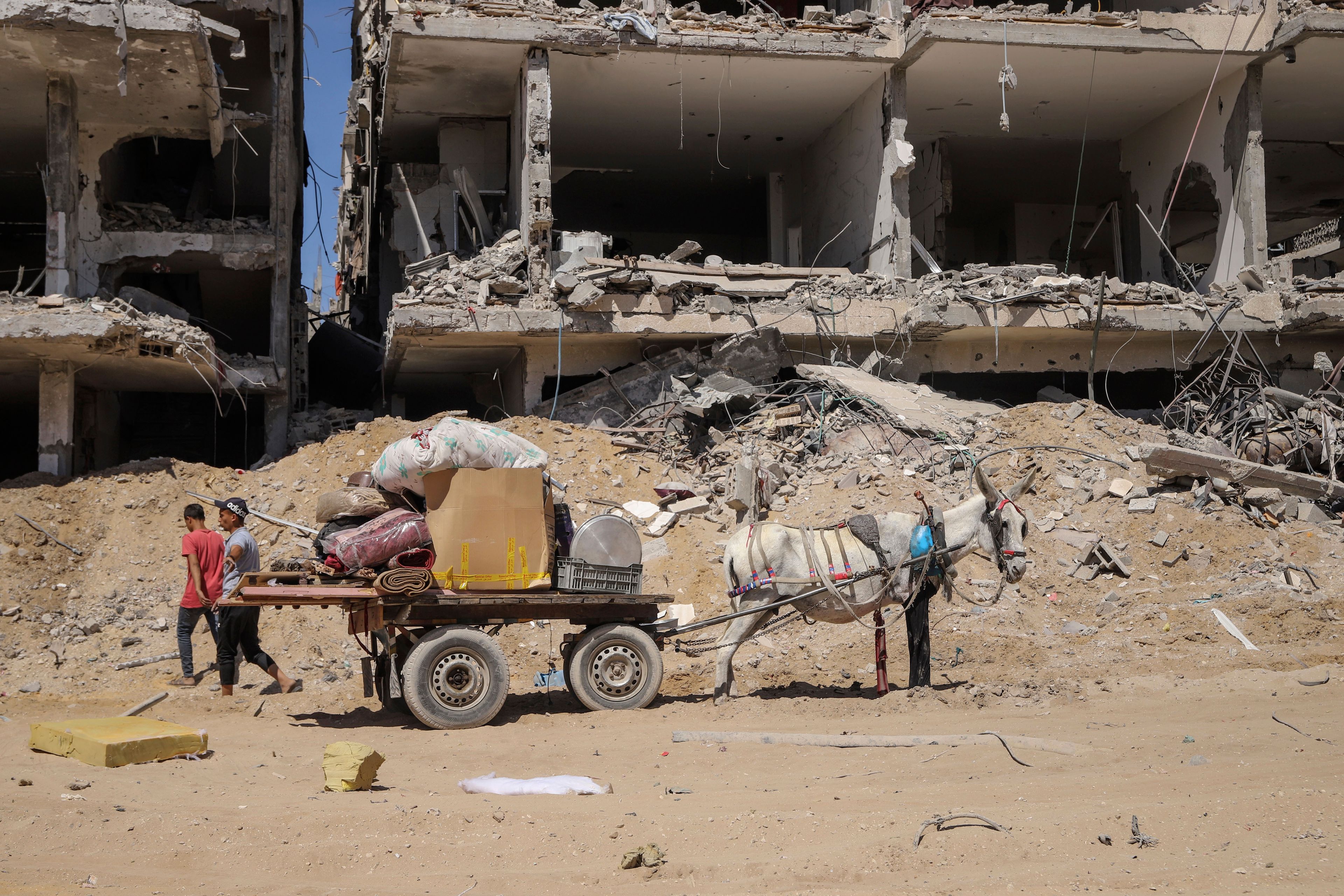 FILE - Palestinians salvage items from the destruction in the wake of an Israeli air and ground offensive in Jebaliya, northern Gaza Strip after Israeli forces withdrew from the area, Friday, May 31, 2024. (AP Photo/Enas Rami, File)