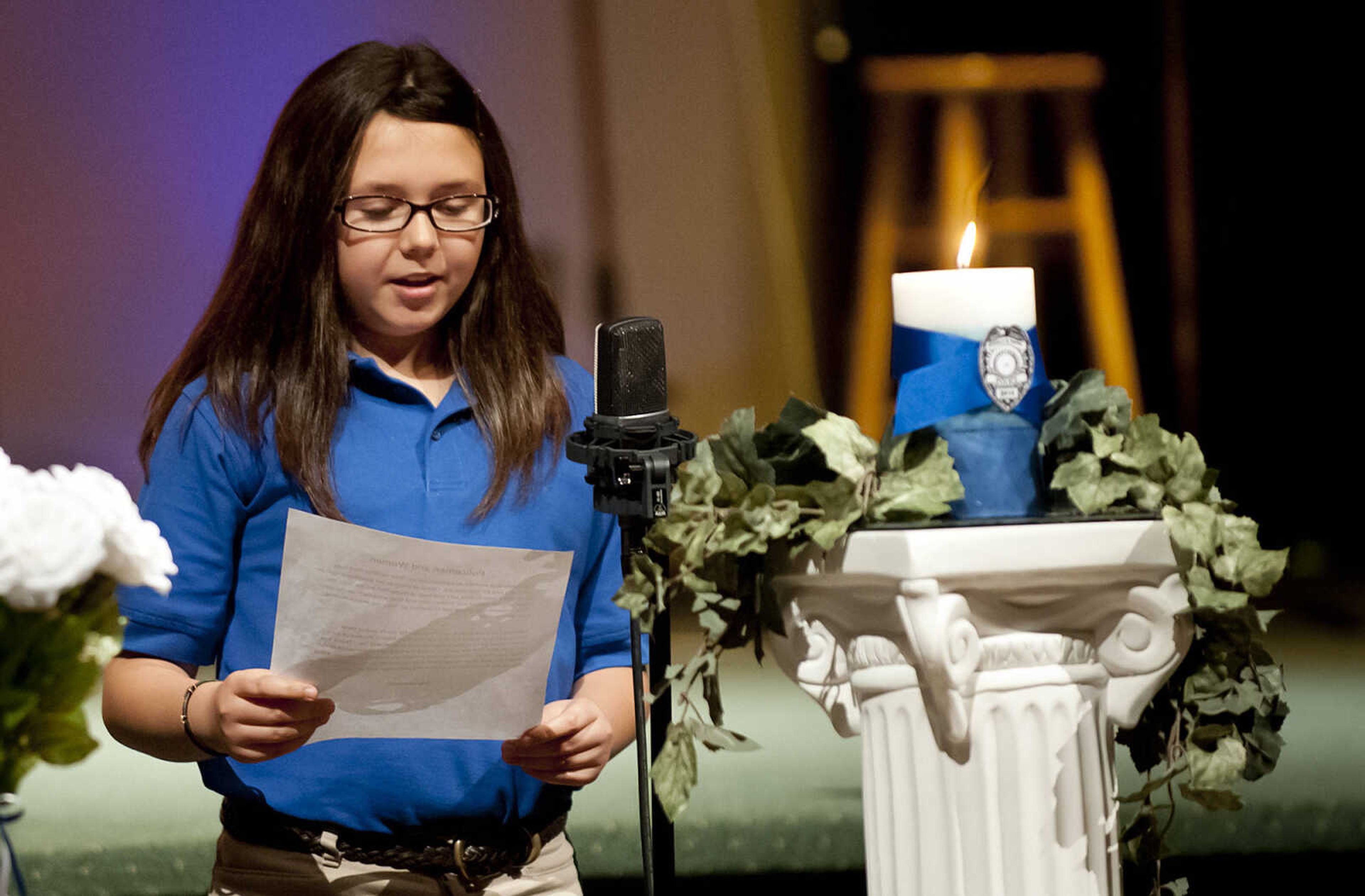 Gigi Merideth, 11,  reads her award-winning essay about police officers during the Senior and Lawmen Together Law Enforcement Memorial Friday, May 9, at the Cape Bible Chapel. The annual memorial honored the 48 Southeast Missouri law enforcement officers that have died in the line of duty since 1875.