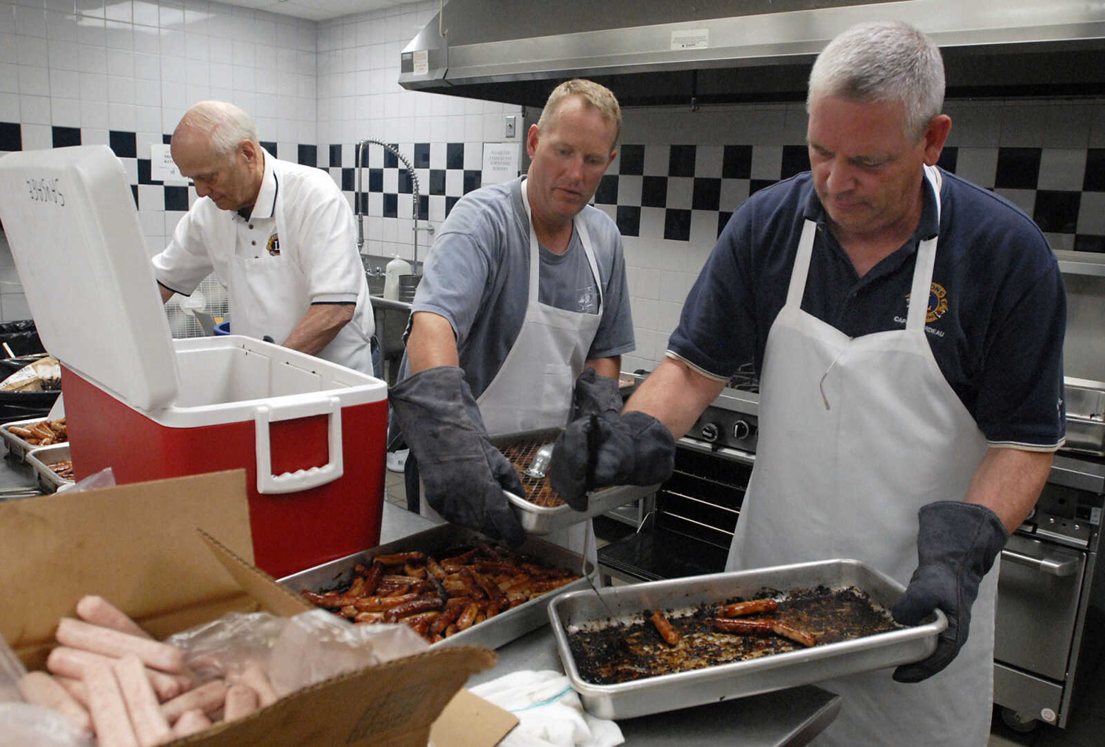 KRISTIN EBERTS ~ keberts@semissourian.com

Rob Williams, Dean Reeves and Kirk Barks, from left, prepare the sausage links during the 73rd annual Pancake Day put on by the Cape Lions Club at the A.C. Brase Arena on Wednesday, March 23, 2011, in Cape Girardeau. More than 10,000 pancakes and 700 pounds of sausage were served.