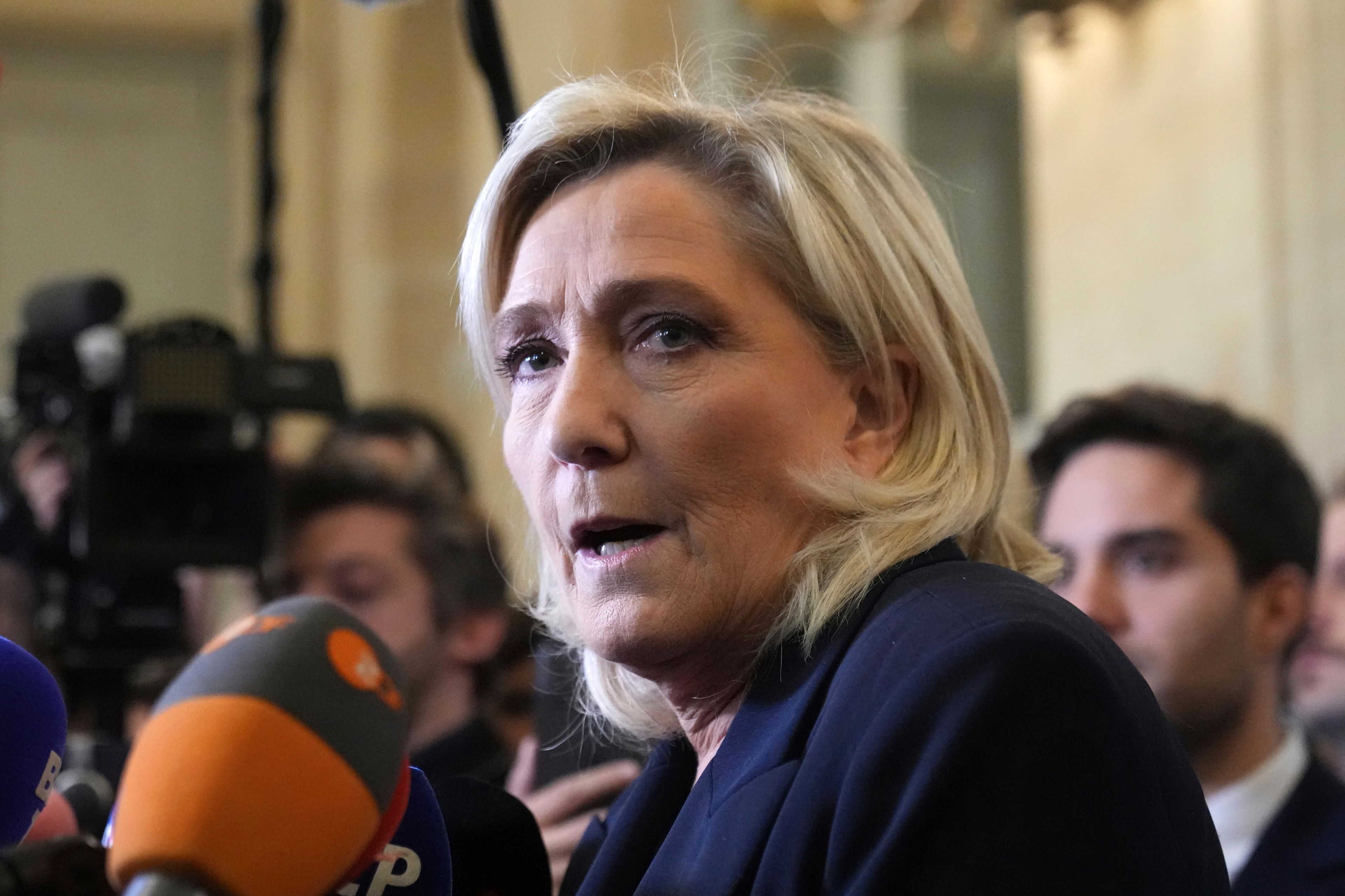 French far-right leader Marine Le Pen answers reporters at the National Assembly to confirm the National Rally party will vote against Prime Minister Michel Barnier in an upcoming no-confidence vote, Monday, Dec. 2, 2024 in Paris. (AP Photo/Michel Euler)