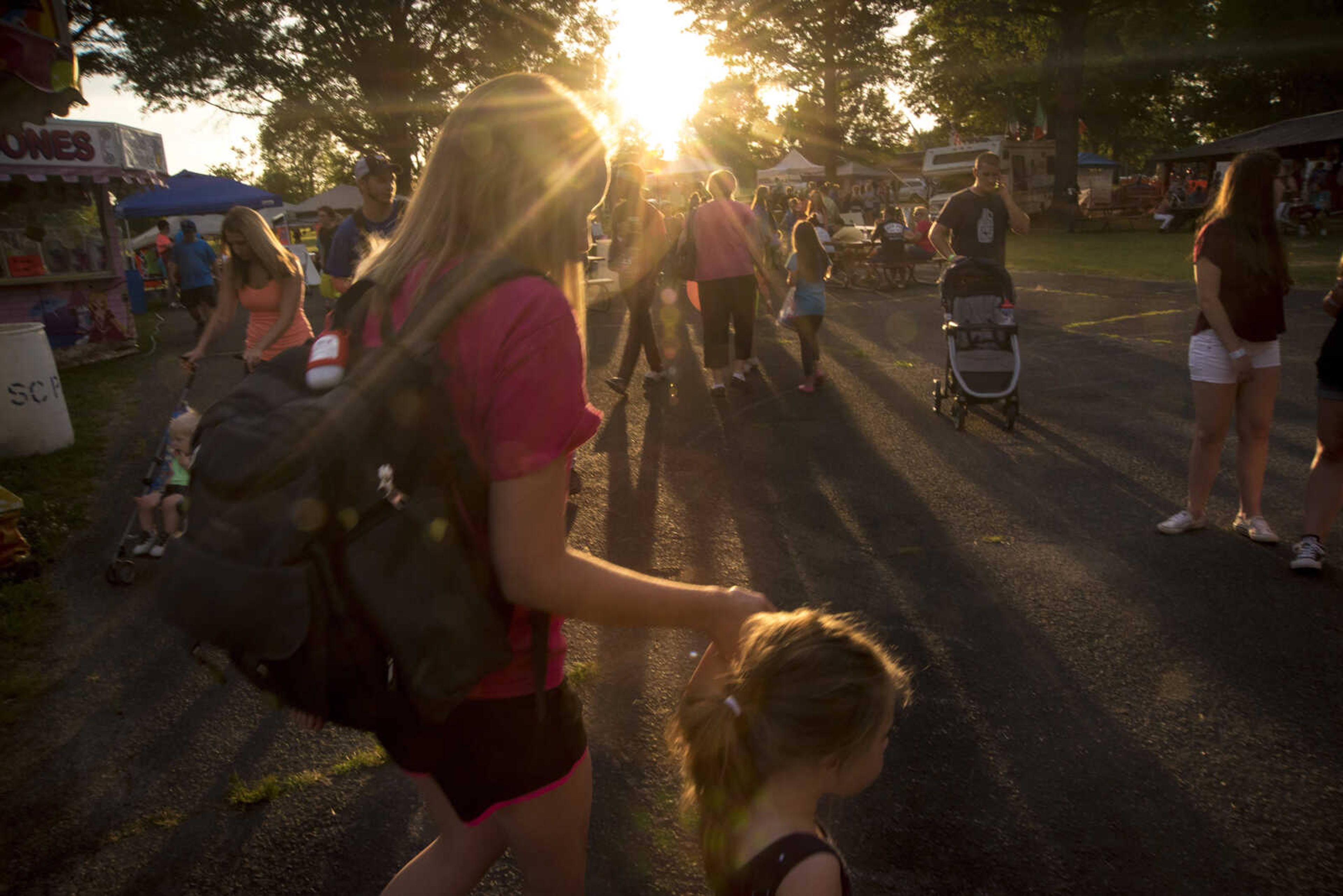 People walk around during the 41st annual Mid-Summer Festival Friday, June 16, 2017 at Scott City Park.