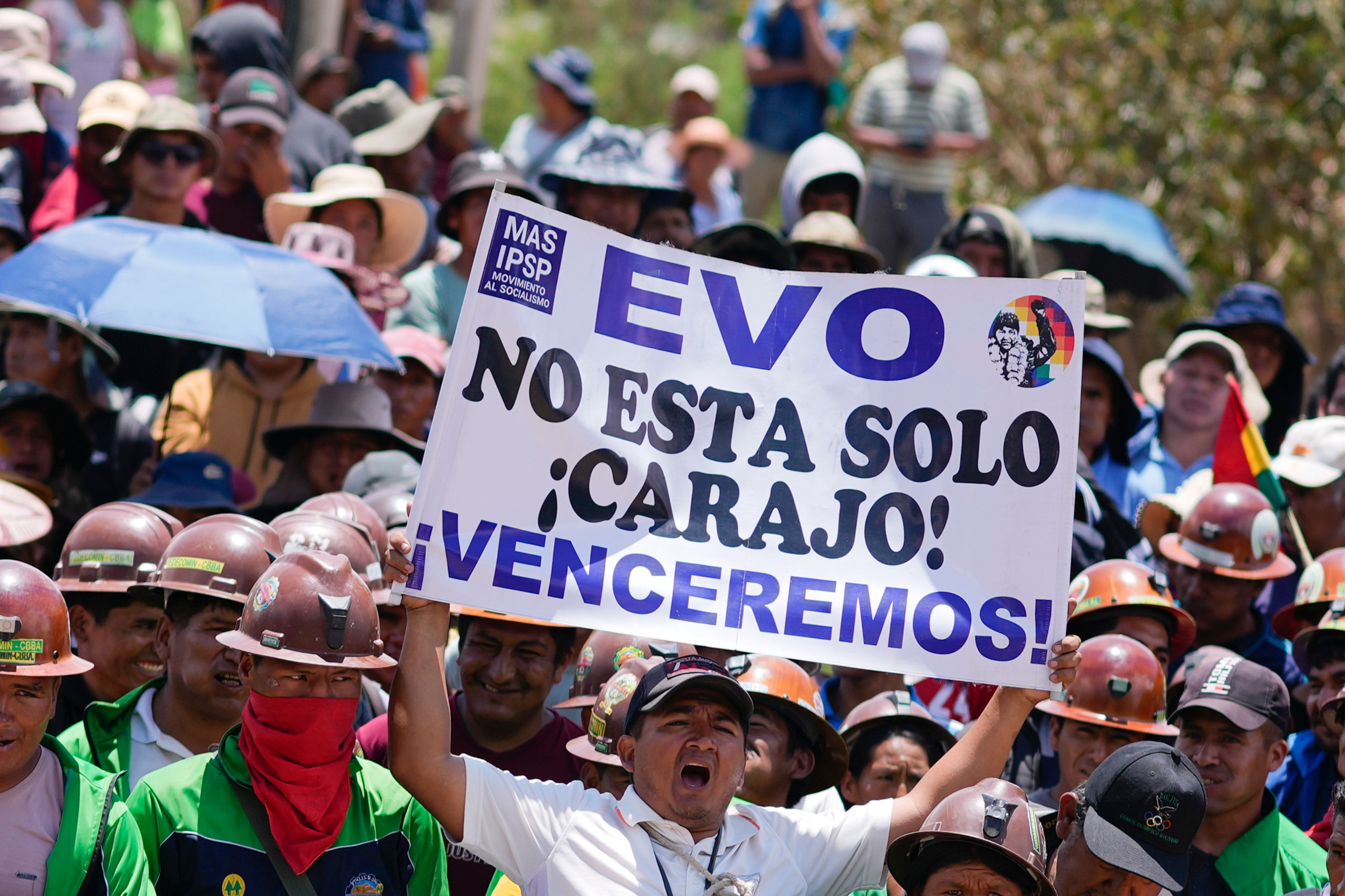 A supporter of Bolivian former President Evo Morales holds a sign with a message that reads in Spanish: " Evo, you are not alone, we will overcome" during a protest to prevent him from facing a criminal investigation over allegations of abuse of a minor and to demonstrate against an alleged assassination attempt, in Parotani, Bolivia, Tuesday, Oct. 29, 2024. (AP Photo/Juan Karita)