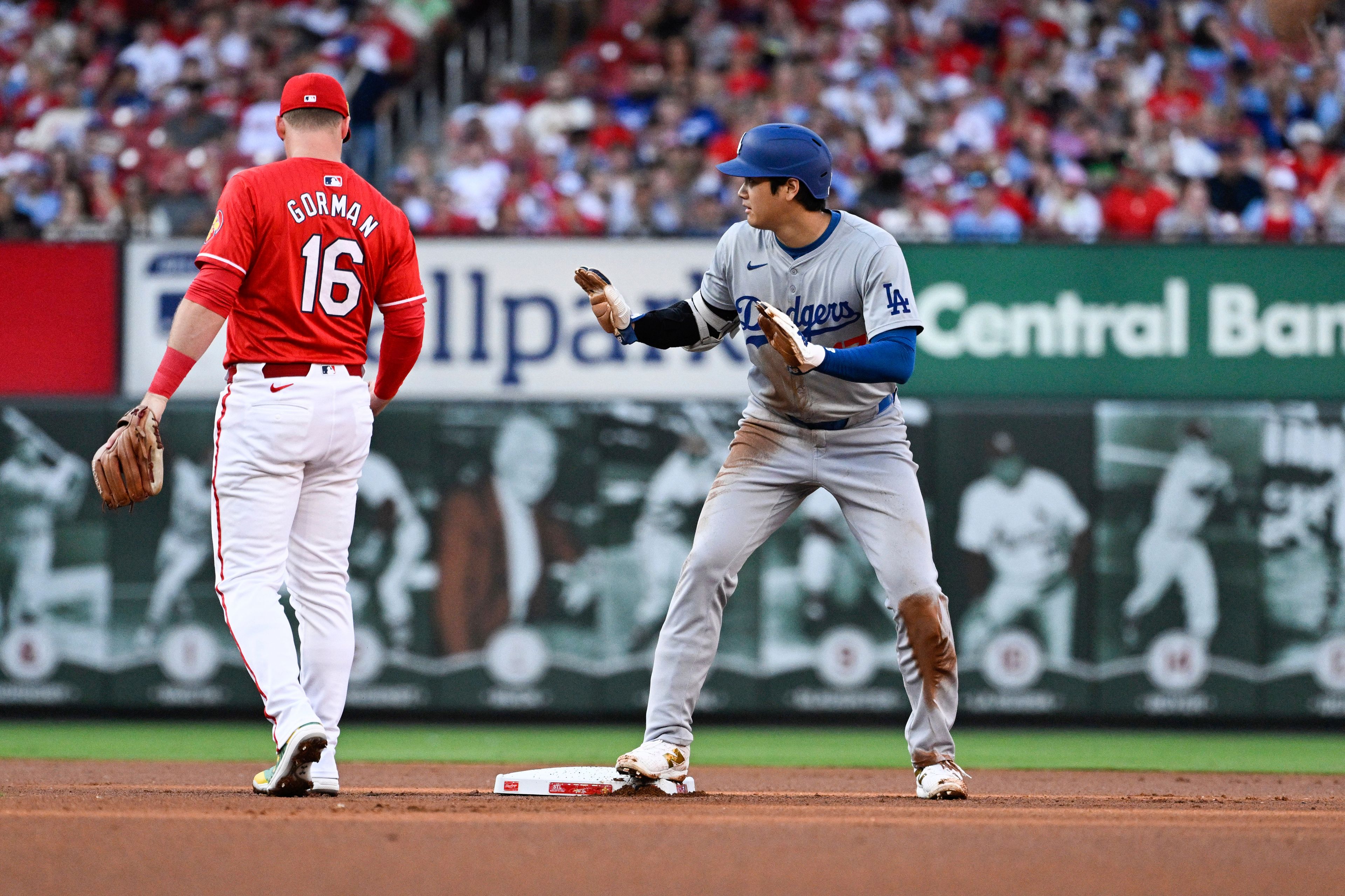 Los Angeles Dodgers' Shohei Ohtani, right, gestures after stealing second during the first inning of a baseball game against the St. Louis Cardinals Saturday, Aug. 17, 2024, in St. Louis. (AP Photo/Jeff Le)