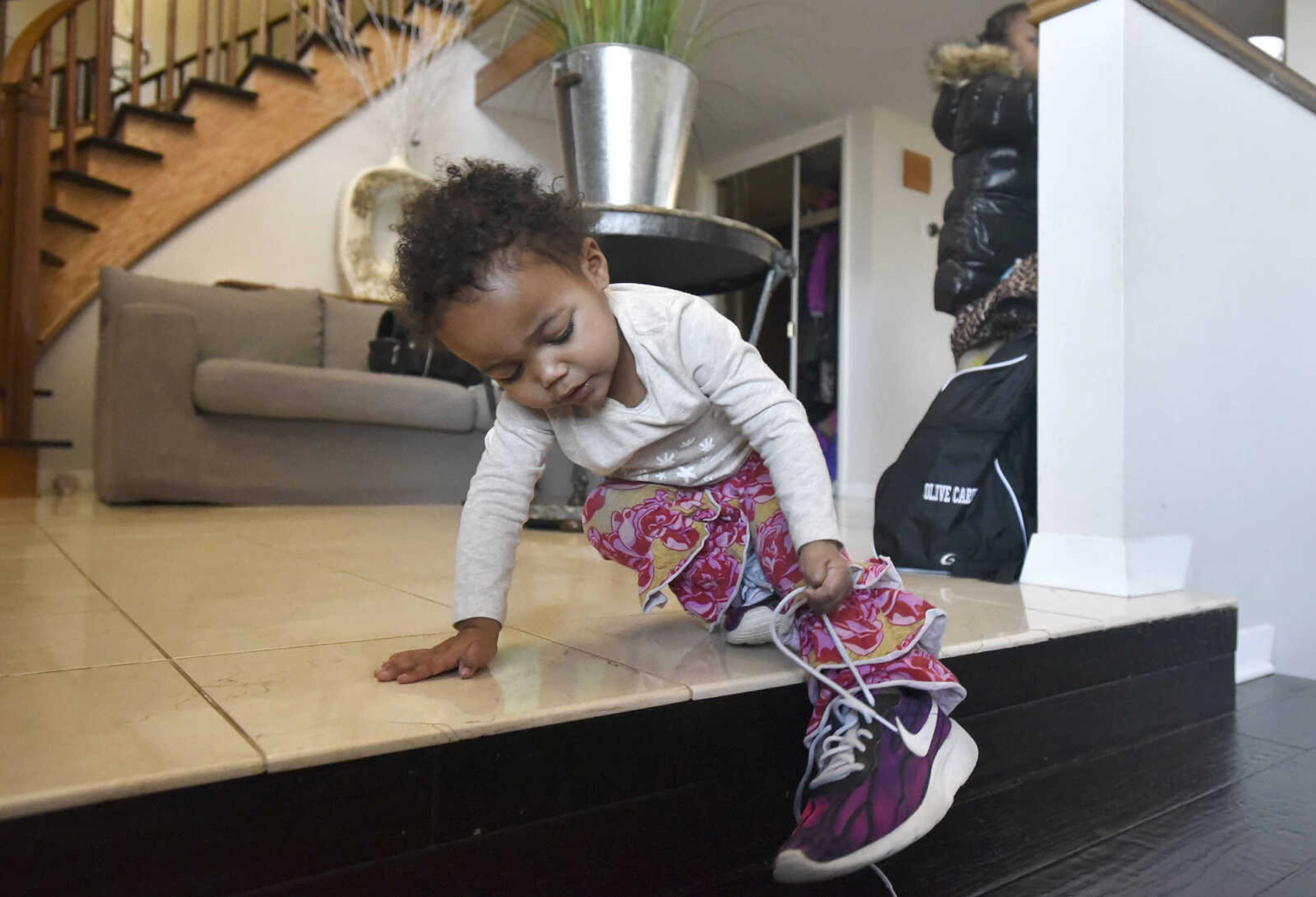 Lennyx Becking, 1, tries on her mother's shoes on Saturday, Jan. 28, 2017, at the Becking's Cape Girardeau home.