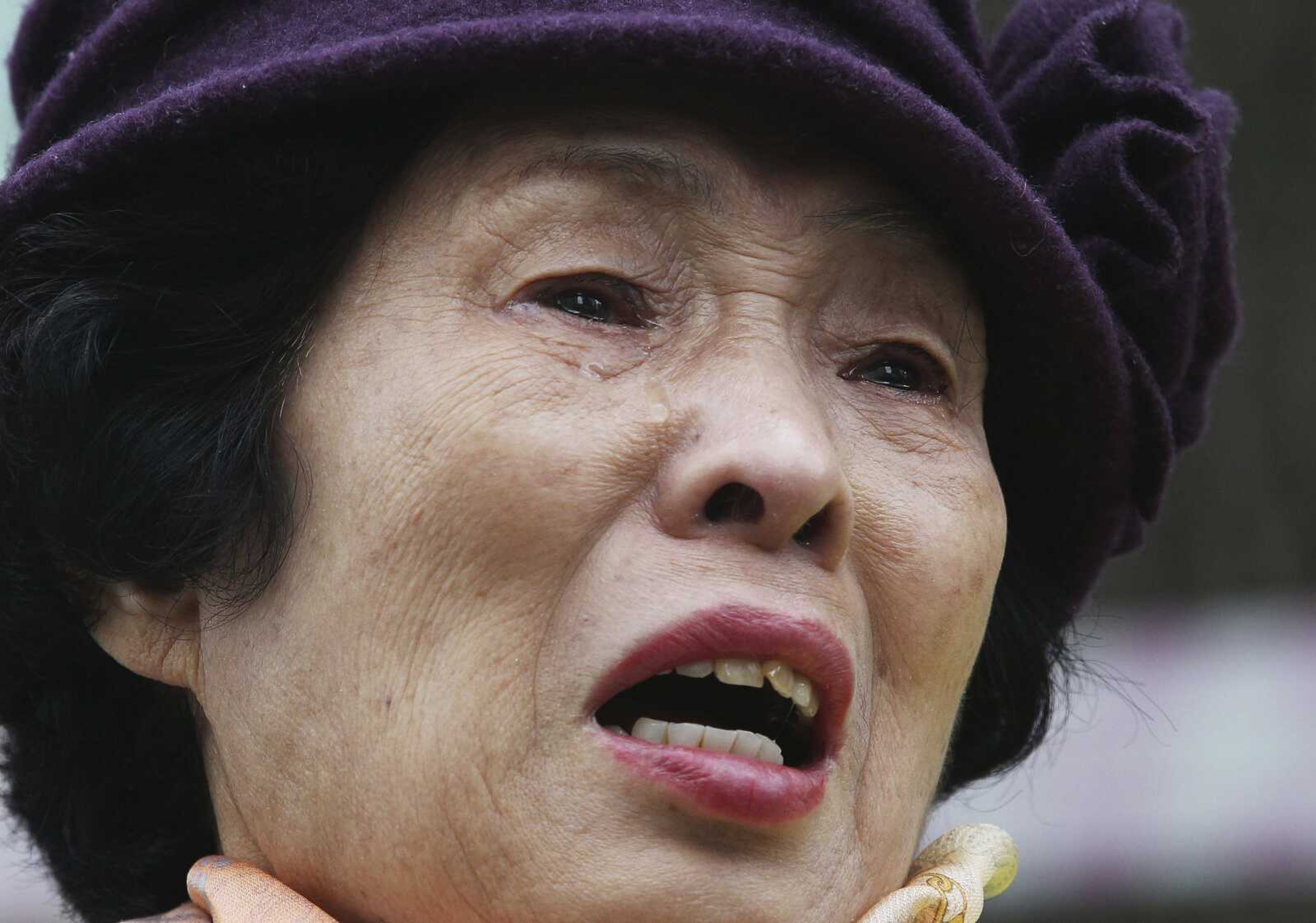 An unidentified South Korean family member of victims of World War II weeps during a rally Monday against Japanese Prime Minister Shinzo Abe's visit in front of the Japanese Embassy in Seoul, South Korea. (Ahn Young-joon ~ Associated Press)